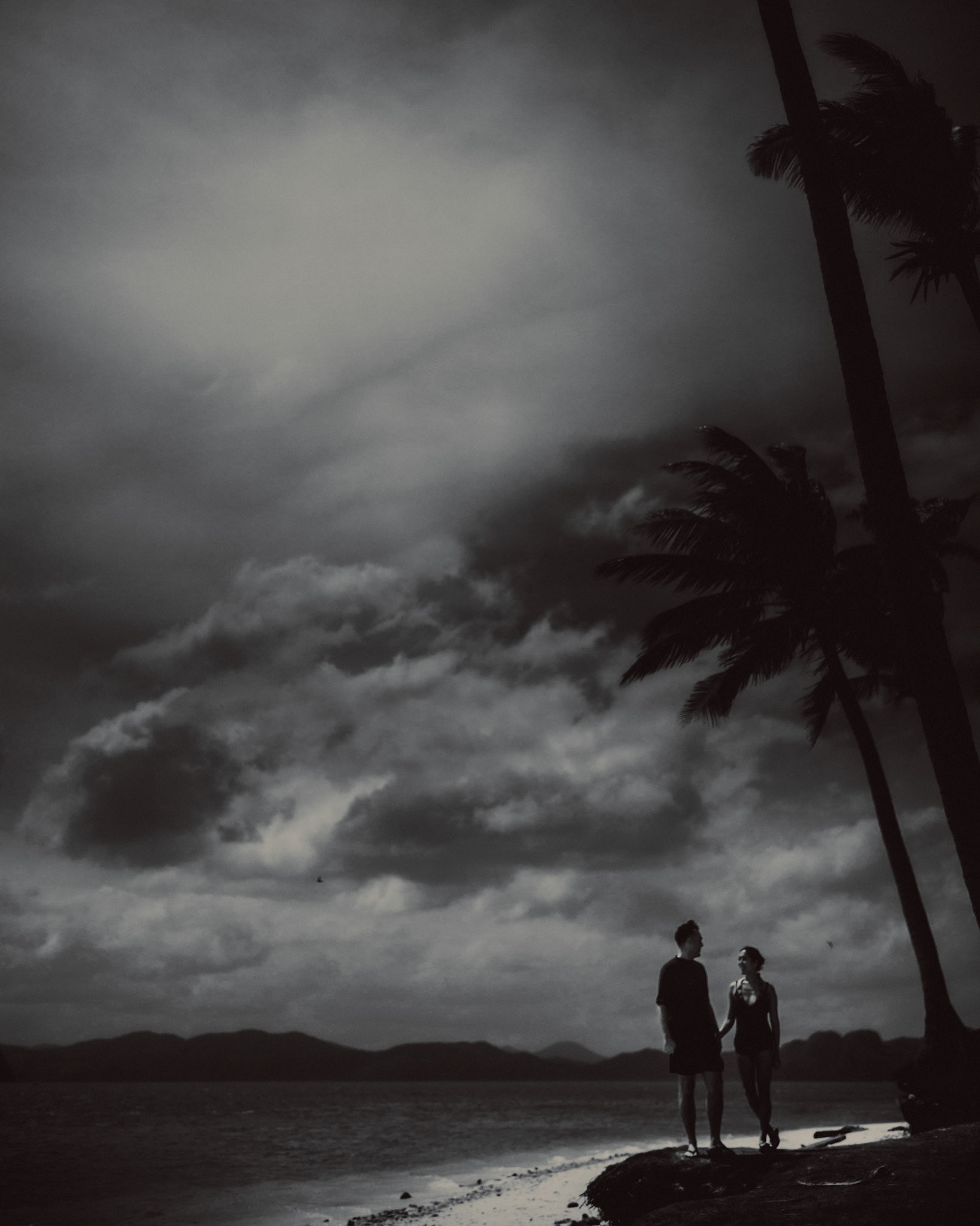 Moody island hopping couple portraits, in black and white, Pinagbuyutan Island, El Nido, Palawan, Philippines, Southeast Asia, January 2017, Leica M