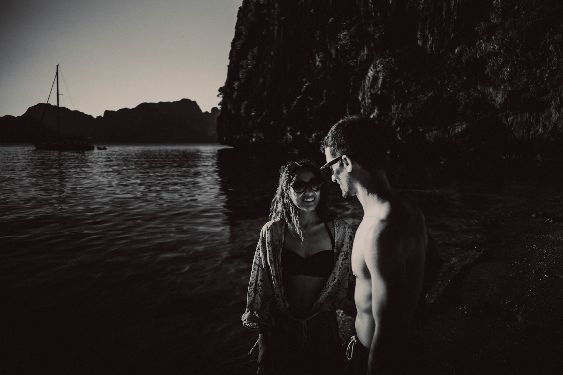 Black and white adventure couple portraits in Entalula Island's secluded west-facing beach just moments before sunset, El Nido, Palawan, Philippines, Southeast Asia, April 2019, Sony A7III.