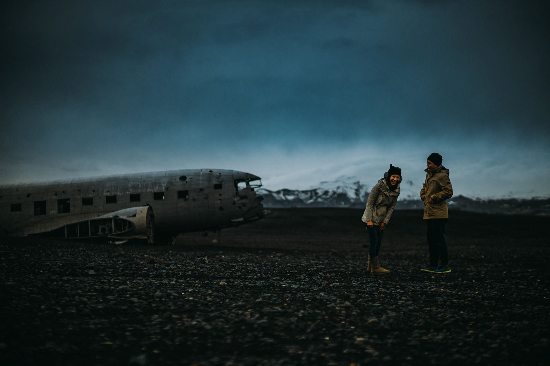 Moody-toned candid adventure engagement portraits at the Sólheimasandur Plane Crash Site, Iceland, May 2016, Sony A7RII.
