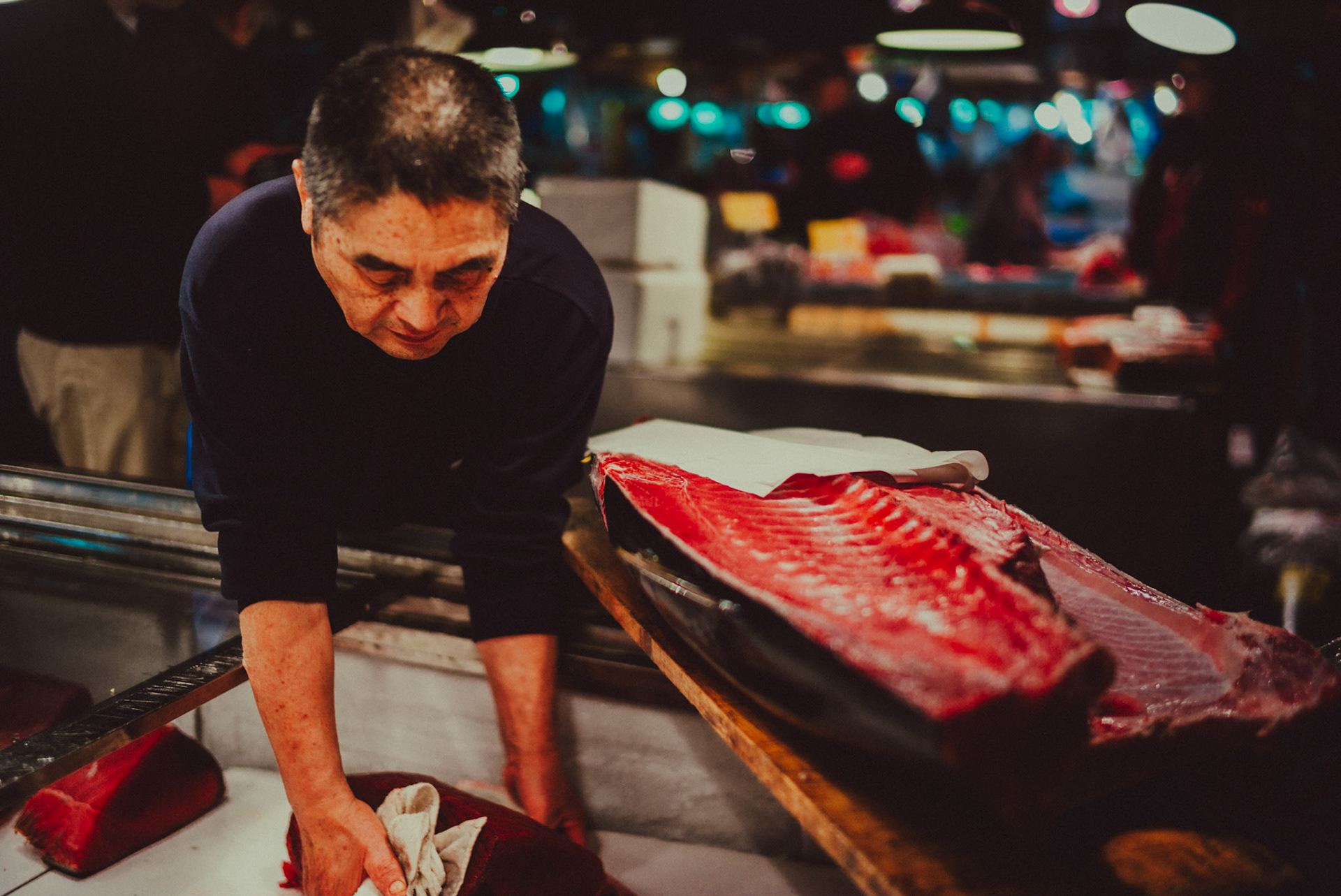 A Japanese man slicing tuna in Tsukiji Market, Tokyo, Japan, December 2016, Leica M.