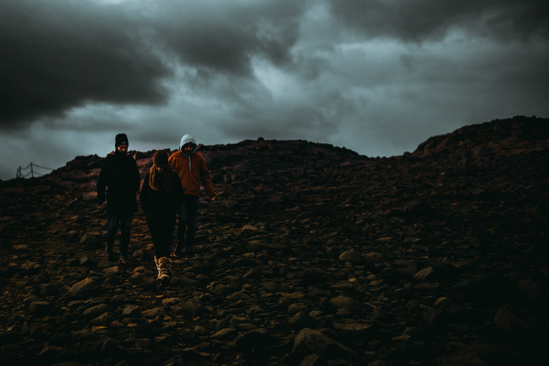 Three travelers hiking down rocky Dyrhólaey Viewpoint, Iceland, May 2016, Leica M.