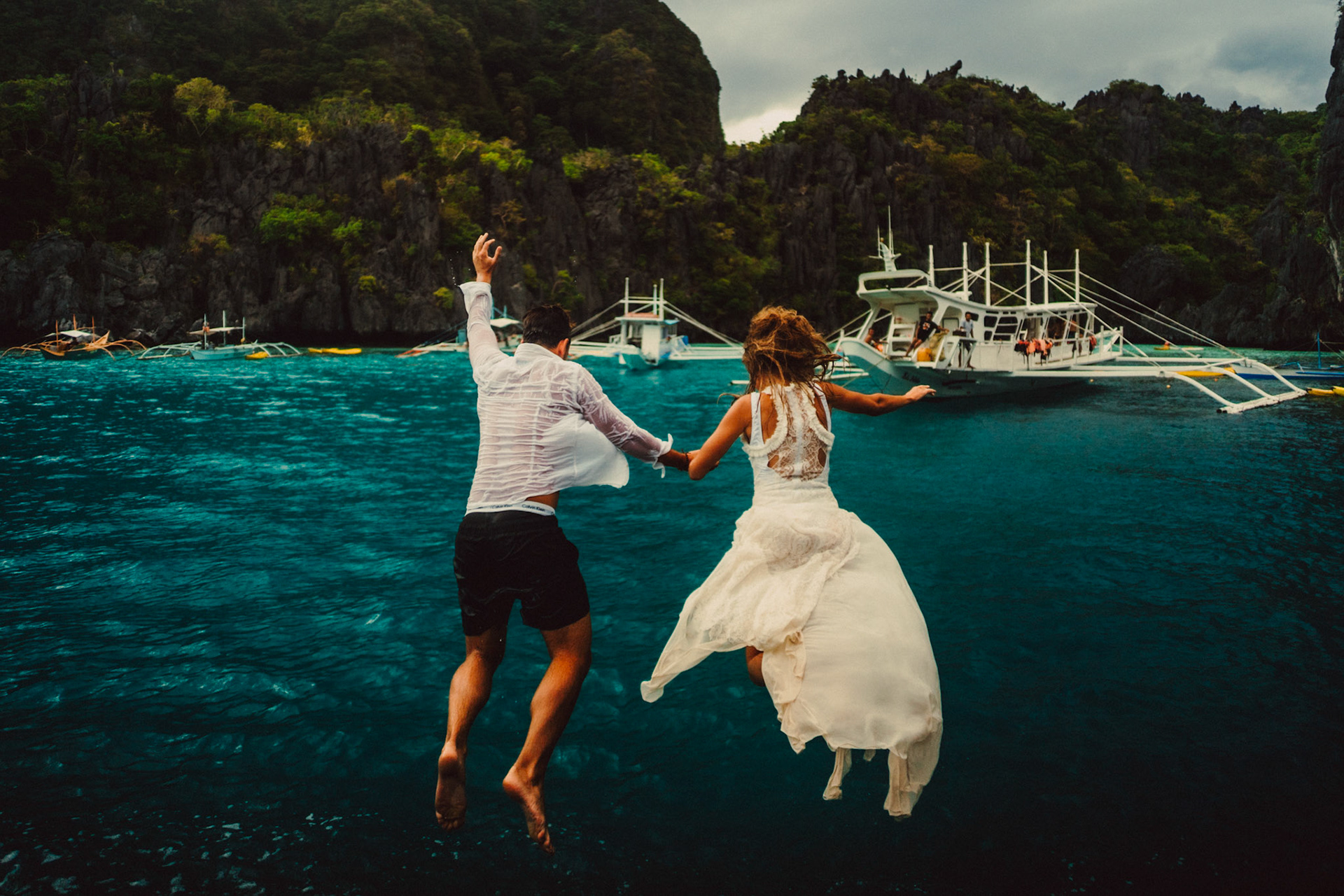 Jumping off a boat outside the Small Lagoon, from Johnny and Sylvia's travel couple honeymoon shoot and island hopping tour in El Nido, Palawan, Philippines, Southeast Asia, December 2019, Sony A7III.