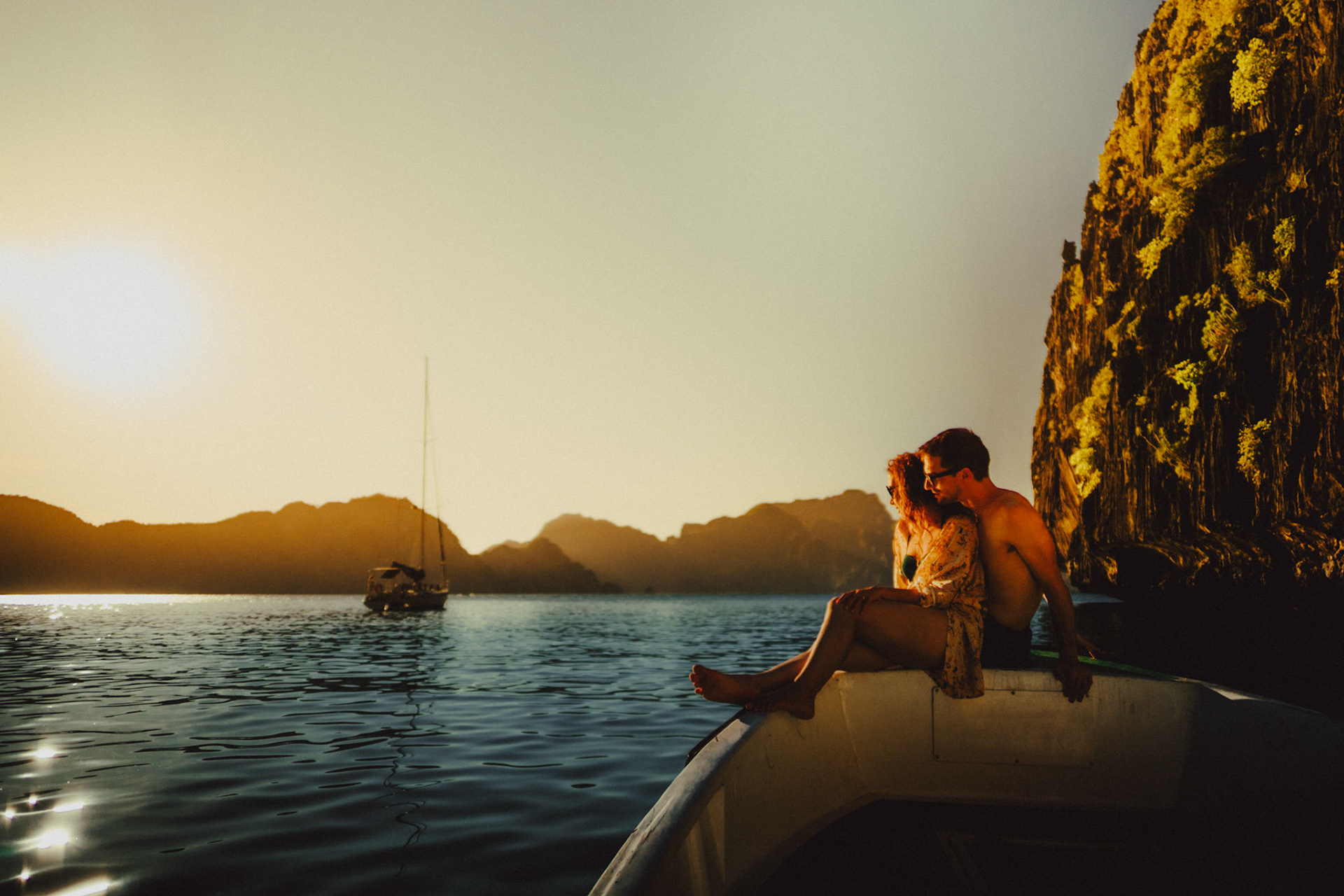 Cozy adventure couple portraits in Entalula Island's secluded west-facing beach just moments before sunset, El Nido, Palawan, Philippines, Southeast Asia, April 2019, Sony A7III.
