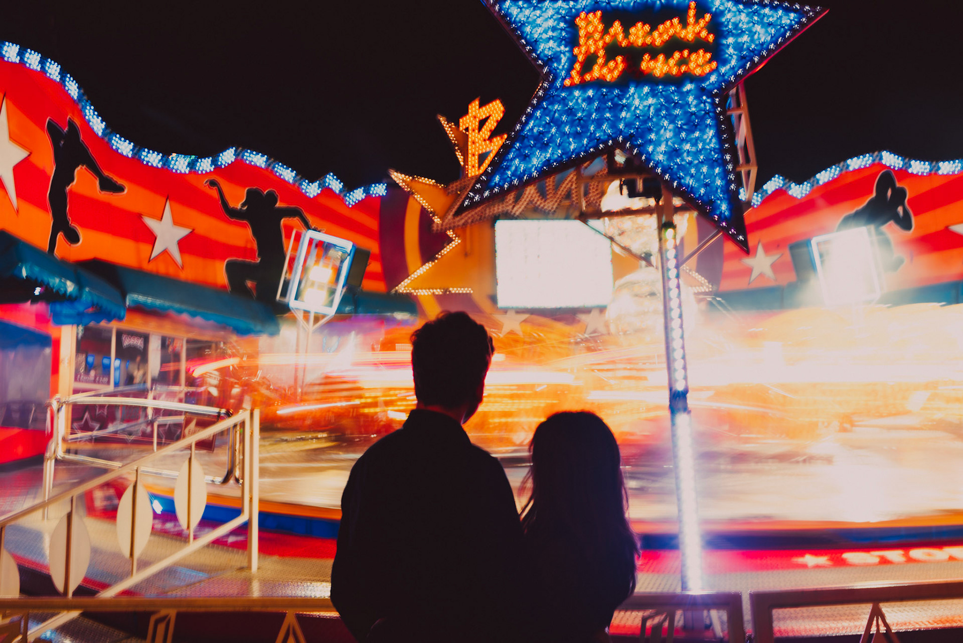 Casual destination engagement photos inspired by "Before Sunrise" movie locations, a carnival ride at Prater, Innere Stadt, Vienna, Austria, August 2017, Sony A7RII.