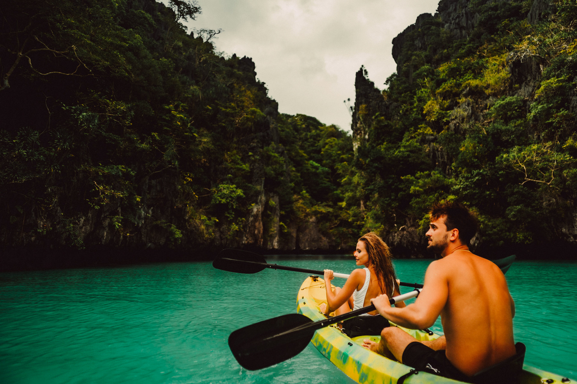 A couple kayaking in Miniloc Island's Small Lagoon with limestone cliffs in the background, El Nido, Palawan, Philippines, Southeast Asia, December 2019, Sony A7III.