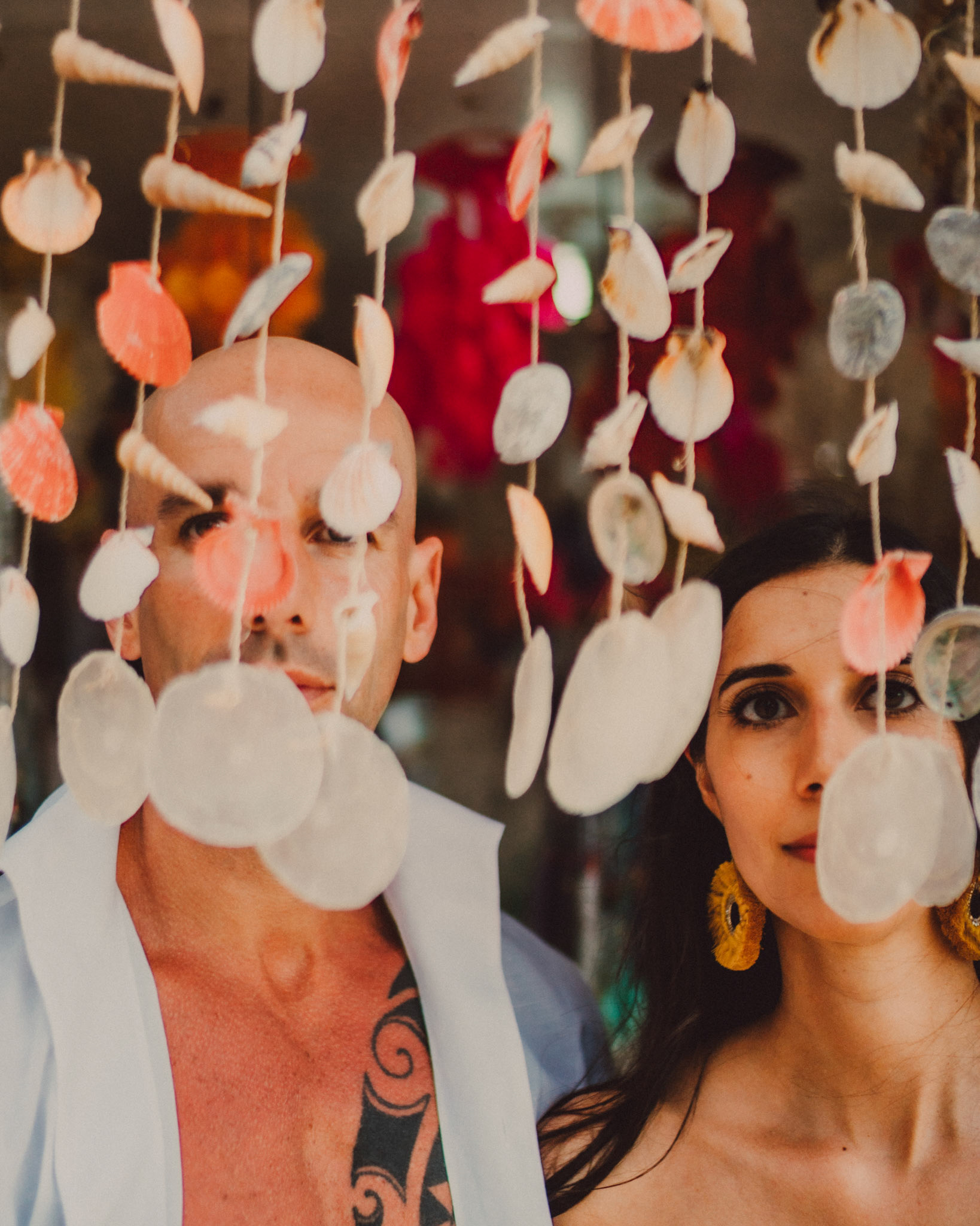 Artsy couple headshots behind seashells, Puka Beach, Boracay, Philippines, Southeast Asia, December 2018, Sony A7III.