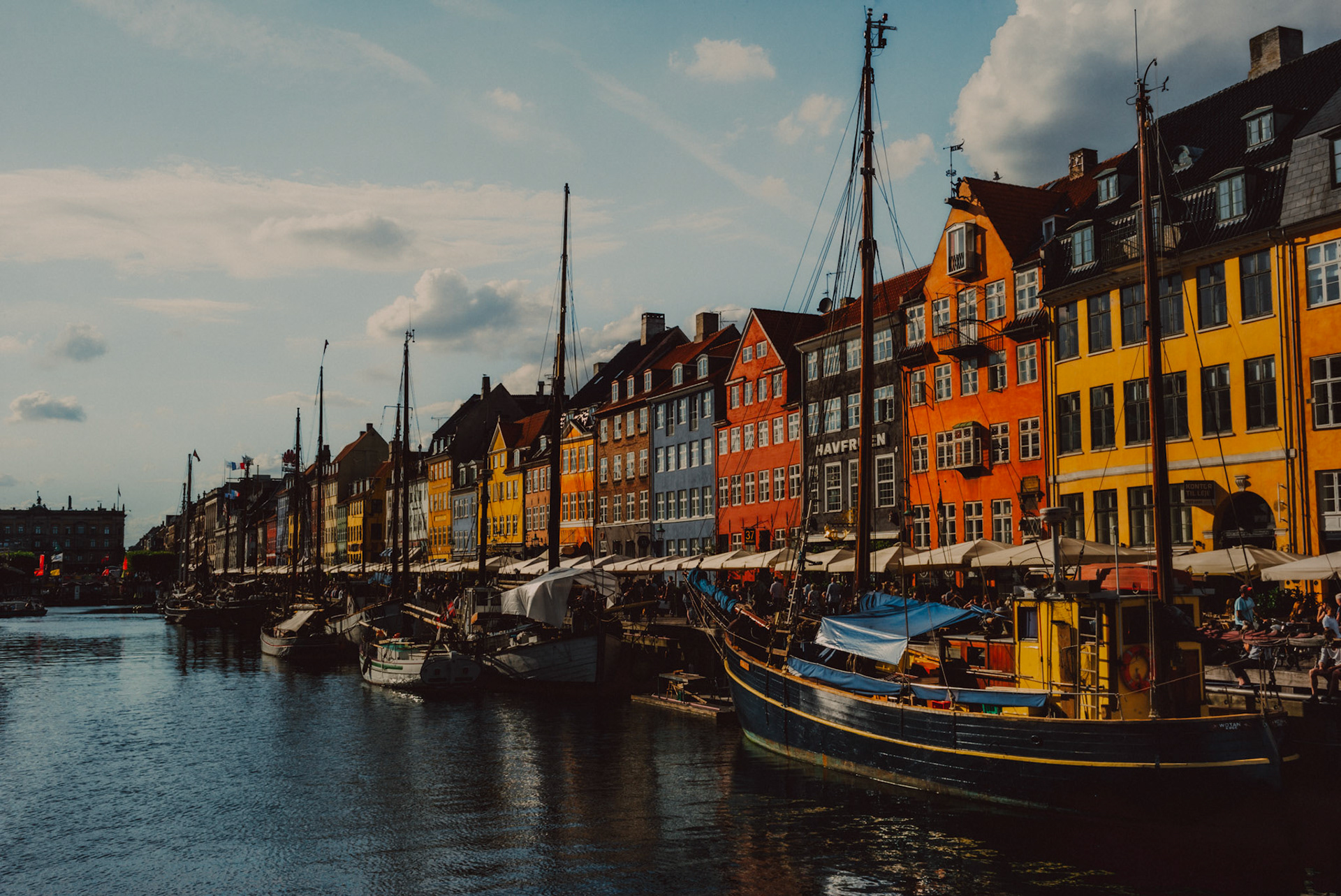 Colorful Danish houses and moored boats in Nyhavn, Copenhagen, Denmark, August 2017, Leica M.