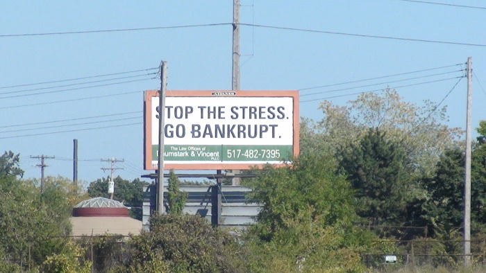 A billboard sits nearby the vacant lot, adding insult to injury.