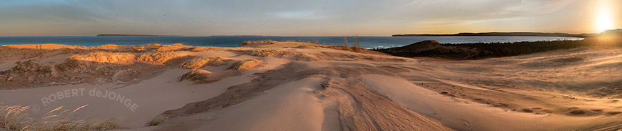 The sun comes up over Glen Arbor and lights up the dunes at Sleeping Bear Point