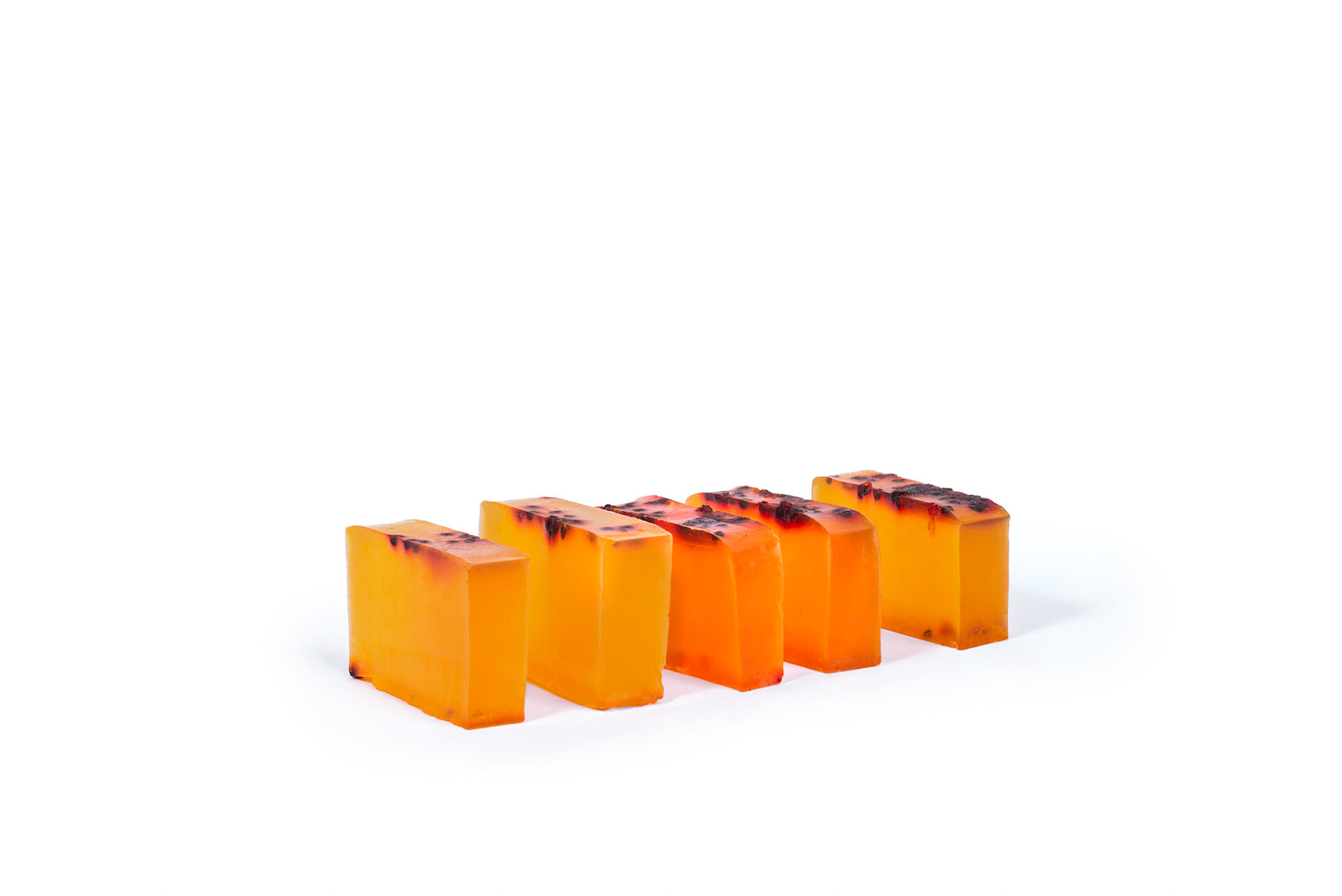 Orange passion fruit soaps arranged in line on white studio background. Still photography, product, ecommerce, e-commerce, shop, online, vibrant, markering, advertising, natural cosmetics, organic. Fotografia produto, loja, vibrante, propaganda, cosméico, orgânico, rio de janeiro. flash, artificial lighting, luz artificial.