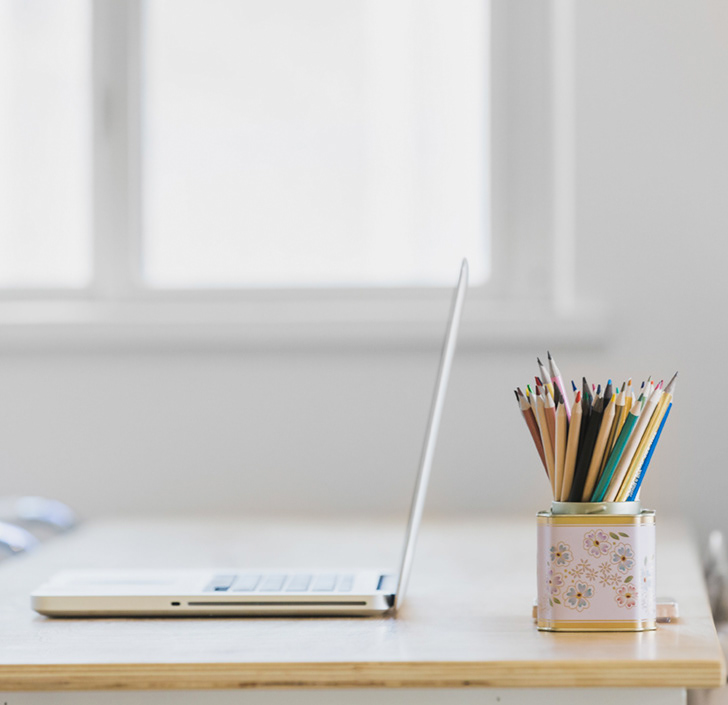 Image of a computer with pencils to illustrate the blog paragraph about editing product photography images - Lindsey L Ahmet graphic designer and photographer