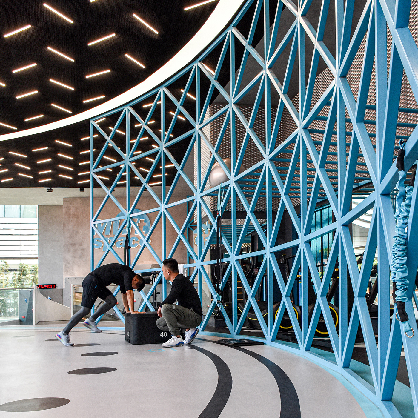 MFIT SPACE the large light blue colored lattice iron structure works as partition and training tool design by RAMOPRIMO