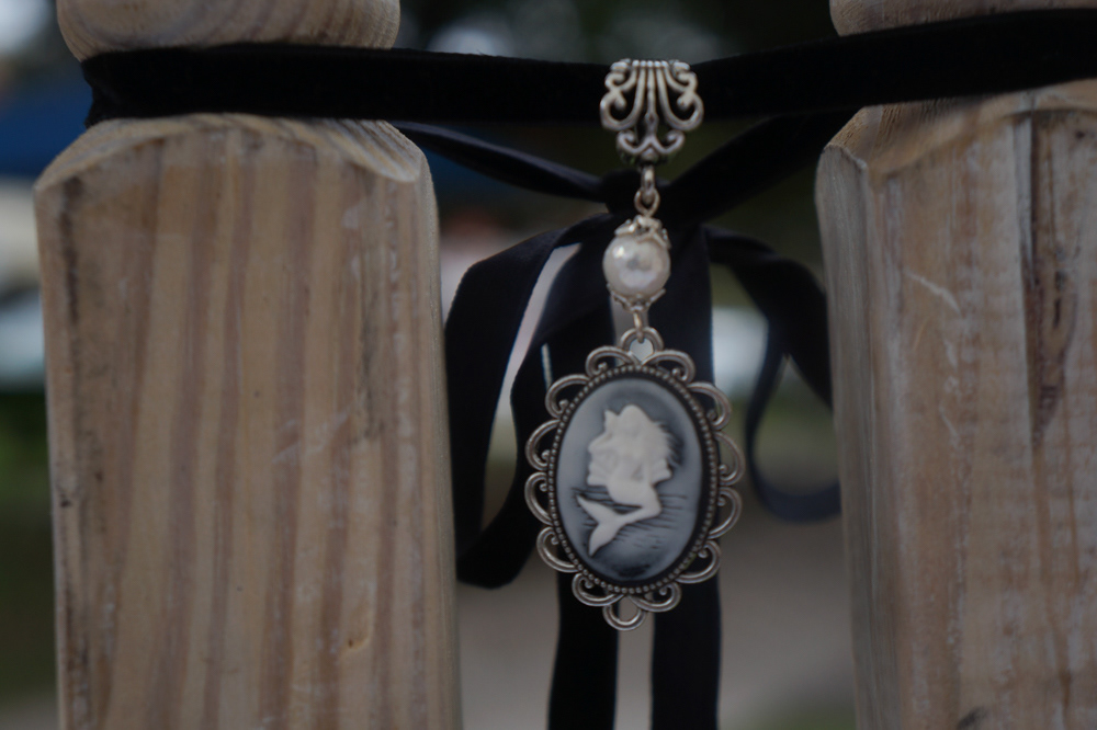 A mermaid necklace hands on display in Debra Hanson’s shop. Many of the materials for her necklaces come from the spines of old leather-bound books. She takes off the metal decor and adds her own special touch.
