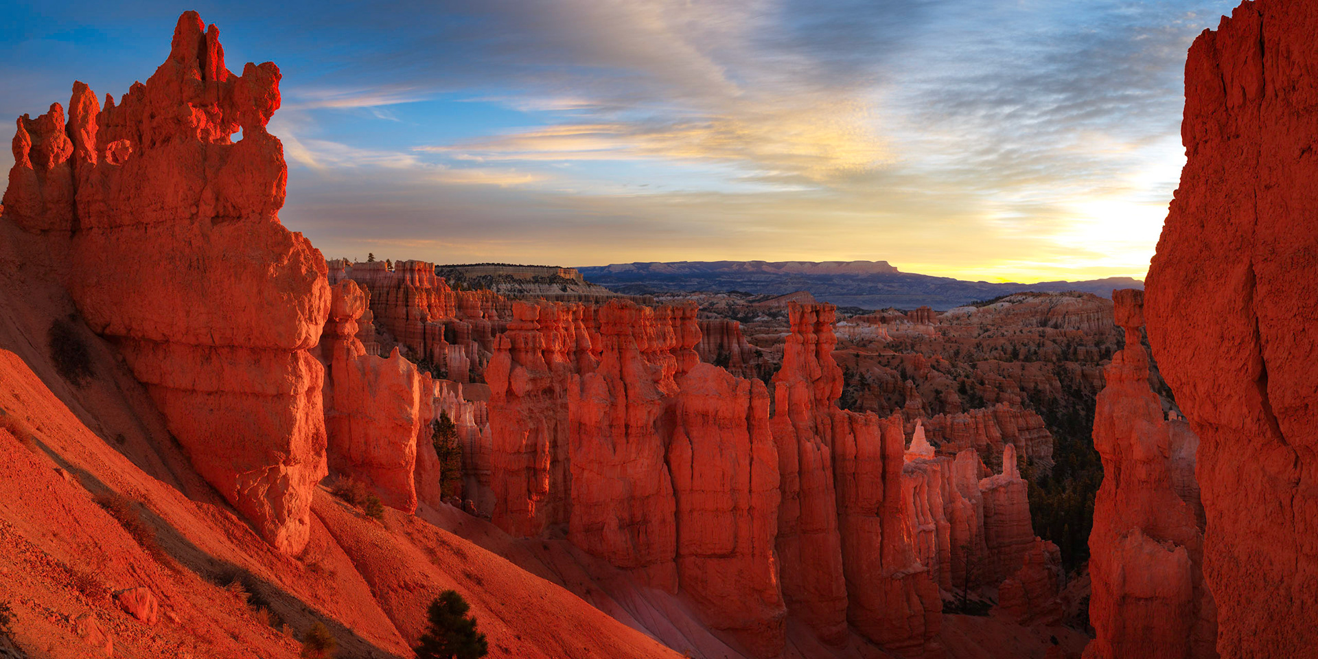 Hoodoos (also called goblins) in Bryce Canyon at sunrise.Bryce Canyon National ParkUtahNovember 10, 2017This is a panoramic images consisting of 3 frames stitched in Photoshop. Additional processing in Lightroom and Photoshop.PENTAX K-1, HD PENTAX-D FA 24-70mm F2.8ED SDM WRISO 100 24 mm  ⅕ sec at ƒ / 11