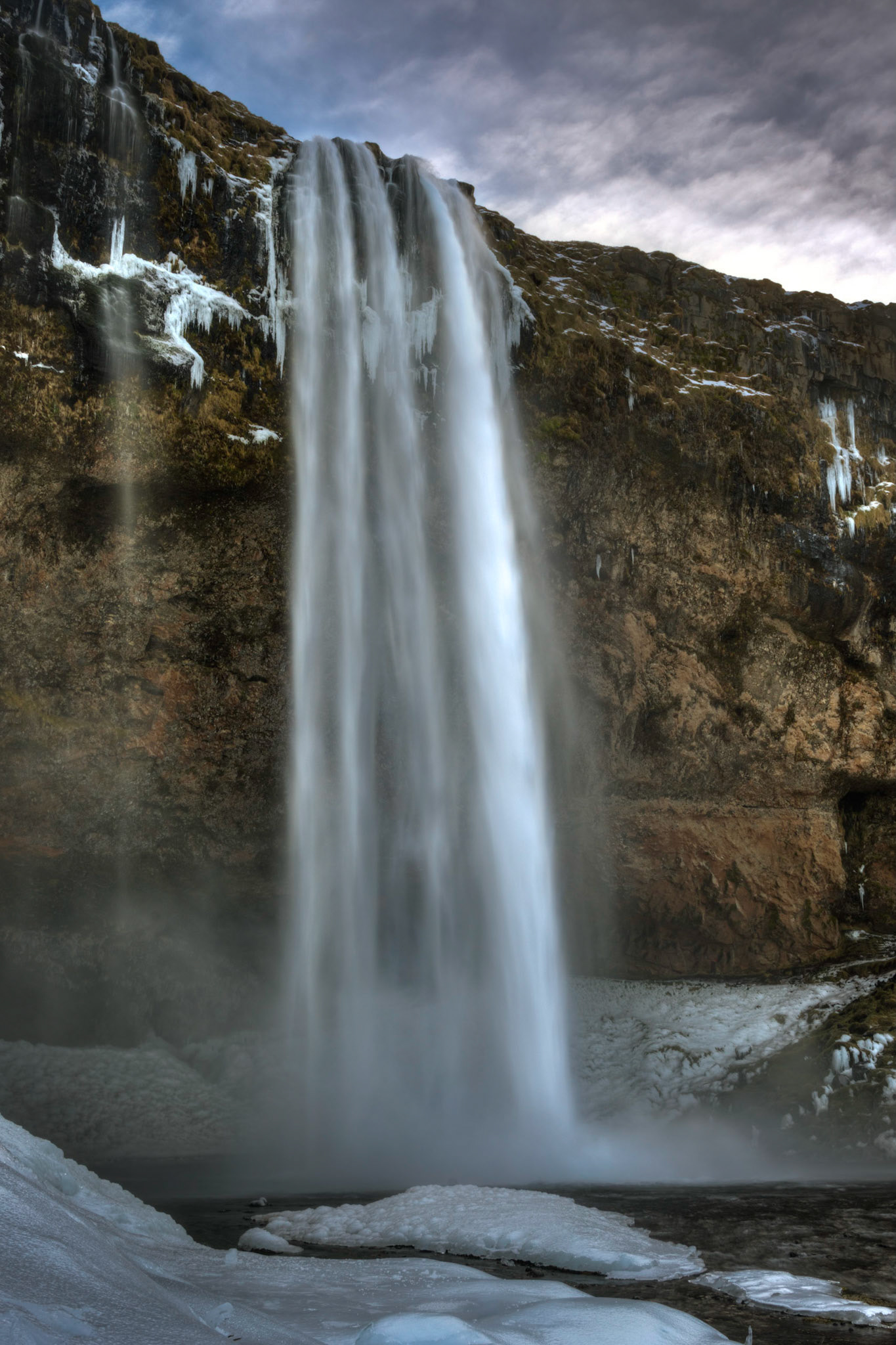 Seljalandsfoss, where the Seljalandsá River descends off of Eyjafjallajökull, shortly before it joins the Markarfjolt.Suðerland, IcelandFebruary 8, 2016This is an HDR image consisting of 5 exposures merged in Photomatix Pro. Additional processing in Lightroom and Photoshop.PENTAX K-3, Sigma 18-250mm f/3.5-6.3 DC OS HSMISO 100 24 mm  ¹⁄₁₃ sec at ƒ / 16