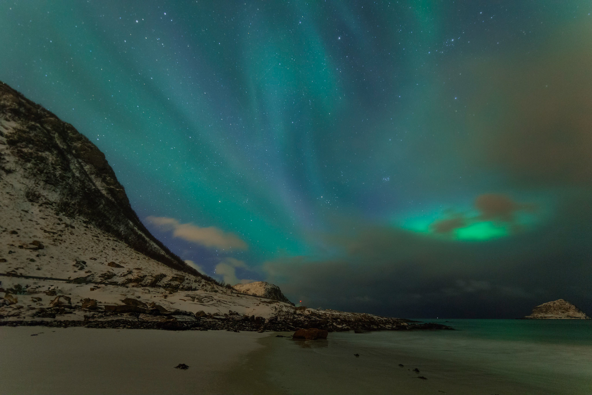 The northern lights dancing behind periodic clouds bringing snow squalls.Leknes, Nordland, NorwayMarch 19, 2018PENTAX K-1, HD PENTAX-D FA 15-30mm F2.8ED SDM WRISO 3200 16 mm  10.0 sec at ƒ / 2.8