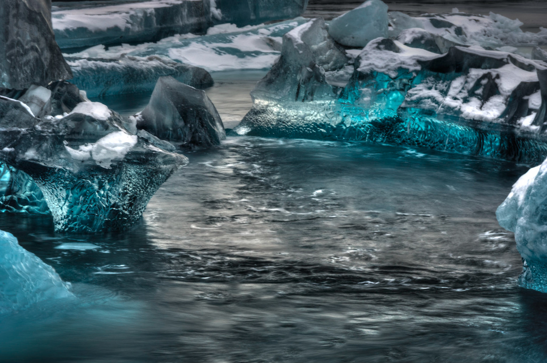 Chunks of ice floating in the glacial lagoon of Jökulsárlón.East, IcelandFebruary 1, 2016This is an HDR image consisting of 5 exposures merged in Photomatix Pro. Additional processing in Lightroom and Photoshop.PENTAX K-3, Sigma 18-250mm f/3.5-6.3 DC OS HSMISO 100 95 mm  0.4 sec at ƒ / 11