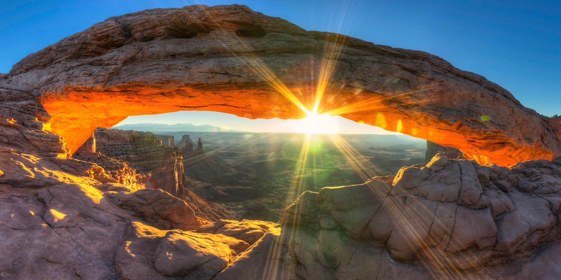 Panoramic shot of Mesa Arch at sunrise.  It would appear that I need to do a better job of cleaning dust off of my lenses.Canyonlands National Park6 November 2014This is an HDR panoramic image consisting of 8 frames comprised of 5 exposures each. HDR processing performed in Photomatix Pro.  Panoramic stitching performed in Photoshop. Additional processing performed in Lightroom and Photoshop.PENTAX K-3, Sigma 10-20mm f/4-5.6 EX DCISO 100 18 mm  0.4 sec at ƒ / 22Prints of my work are available from my website at http://www.fingolfinphoto.comFollow me on Facebook at http://www.facebook.com/fingolfinphoto or http://www.facebook.com/pesterleAlso, http://500px.com/pesterle   http://www.flickr.com/photos/fingolfinphoto