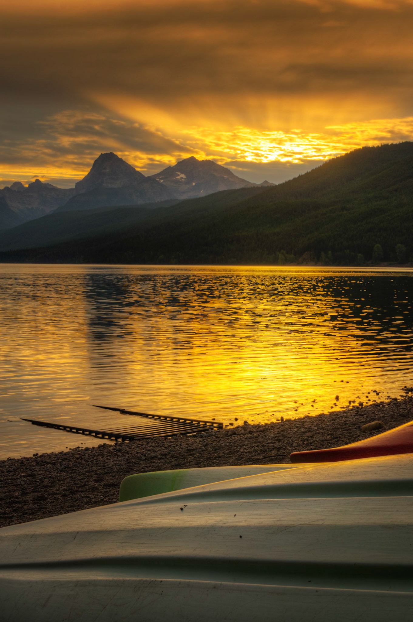 Sunrise at Lake McDonald, near Apgar Village.Glacier National ParkJuly 27, 2015This is an HDR image consisting of 5 exposures merged in Photomatix Pro. Additional processing in Lightroom and Photoshop.PENTAX K-3, Sigma 18-250mm f/3.5-6.3 DC OS HSMISO 100 37 mm  ¹⁄₂₅ sec at ƒ / 11