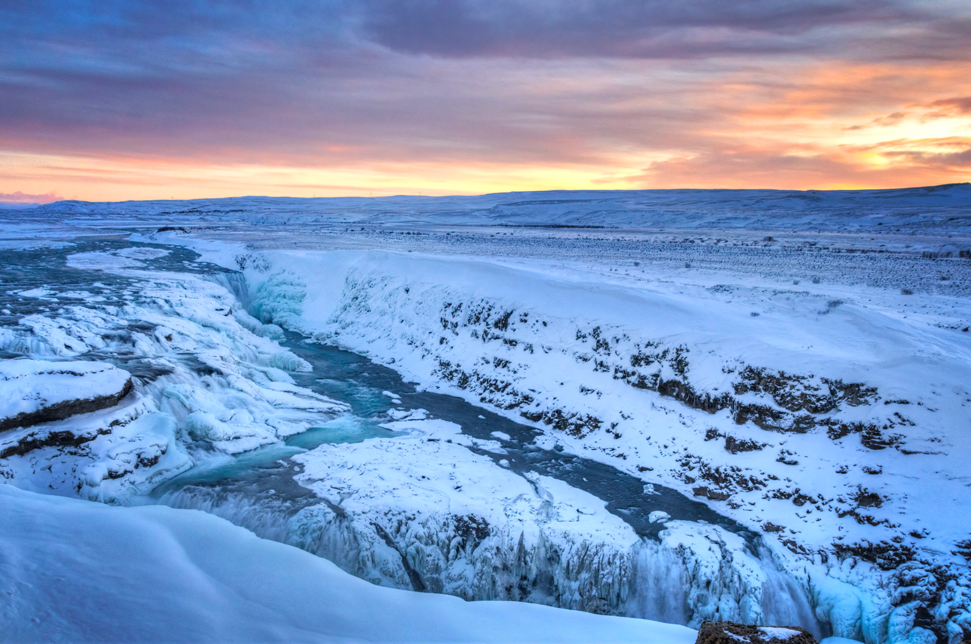 Gullfoss at sunrise.  Imagine looking at this while being blasted by 50mph winds.Suðerland, IcelandFebruary 8, 2016This is an HDR image consisting of 5 exposures merged in Photomatix Pro. Additional processing in Lightroom and Photoshop.PENTAX K-3, Sigma 18-250mm f/3.5-6.3 DC OS HSMISO 800 18 mm  ¹⁄₁₂₅ sec at ƒ / 8.0