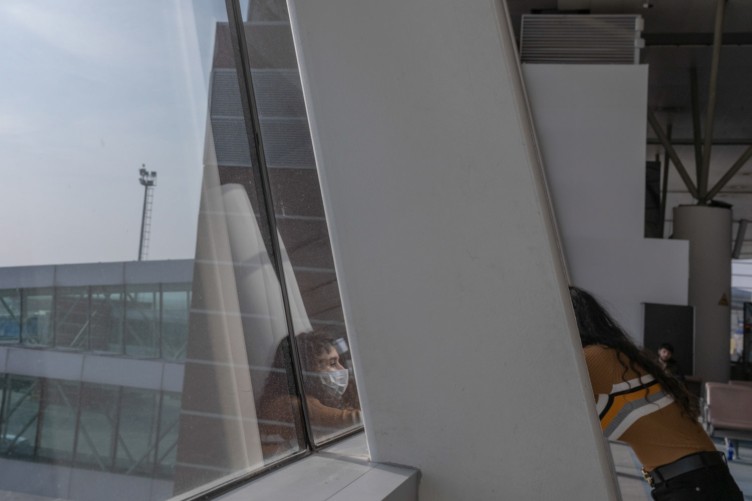 People who wait for their Istanbul flight in Tbilisi Airport in Georgian