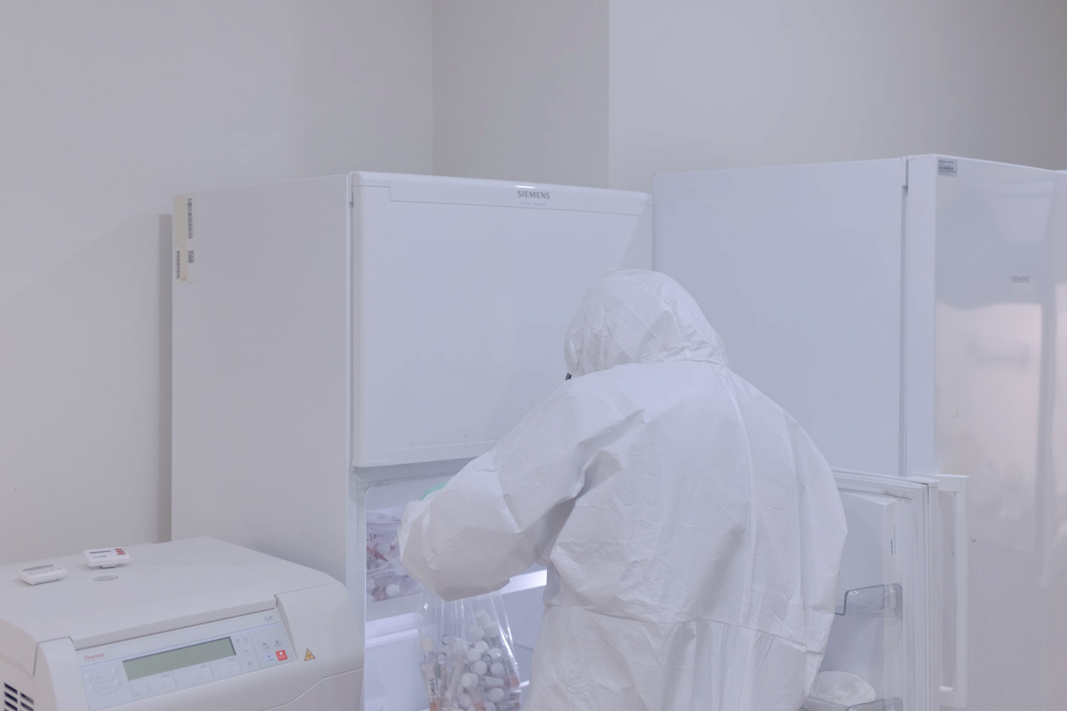 A molecular biologist wearing protective equipment as they look for patient samples in freezer in a high safety laboratory chamber at a private hospital in Istanbul on 1 May 2020.