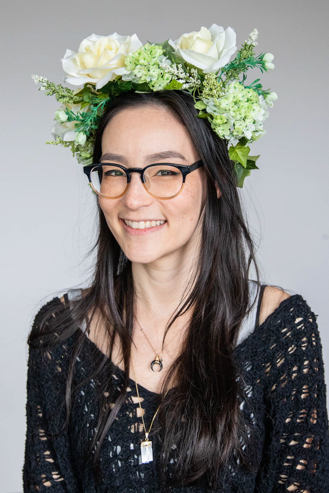 Company head shot of young woman showing her character with a flower crown
