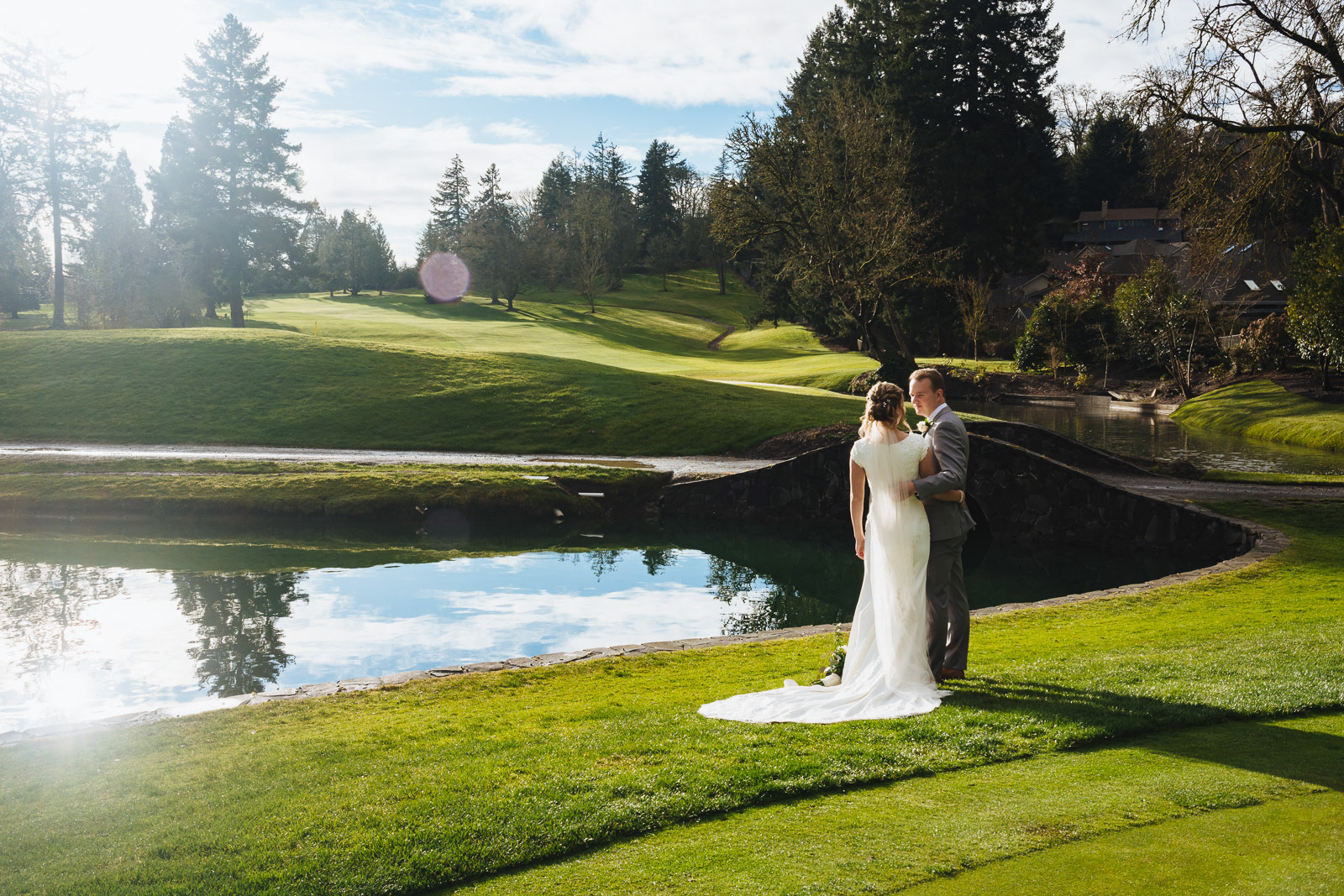 Bride and groom in green landscape at Eugene Country Club