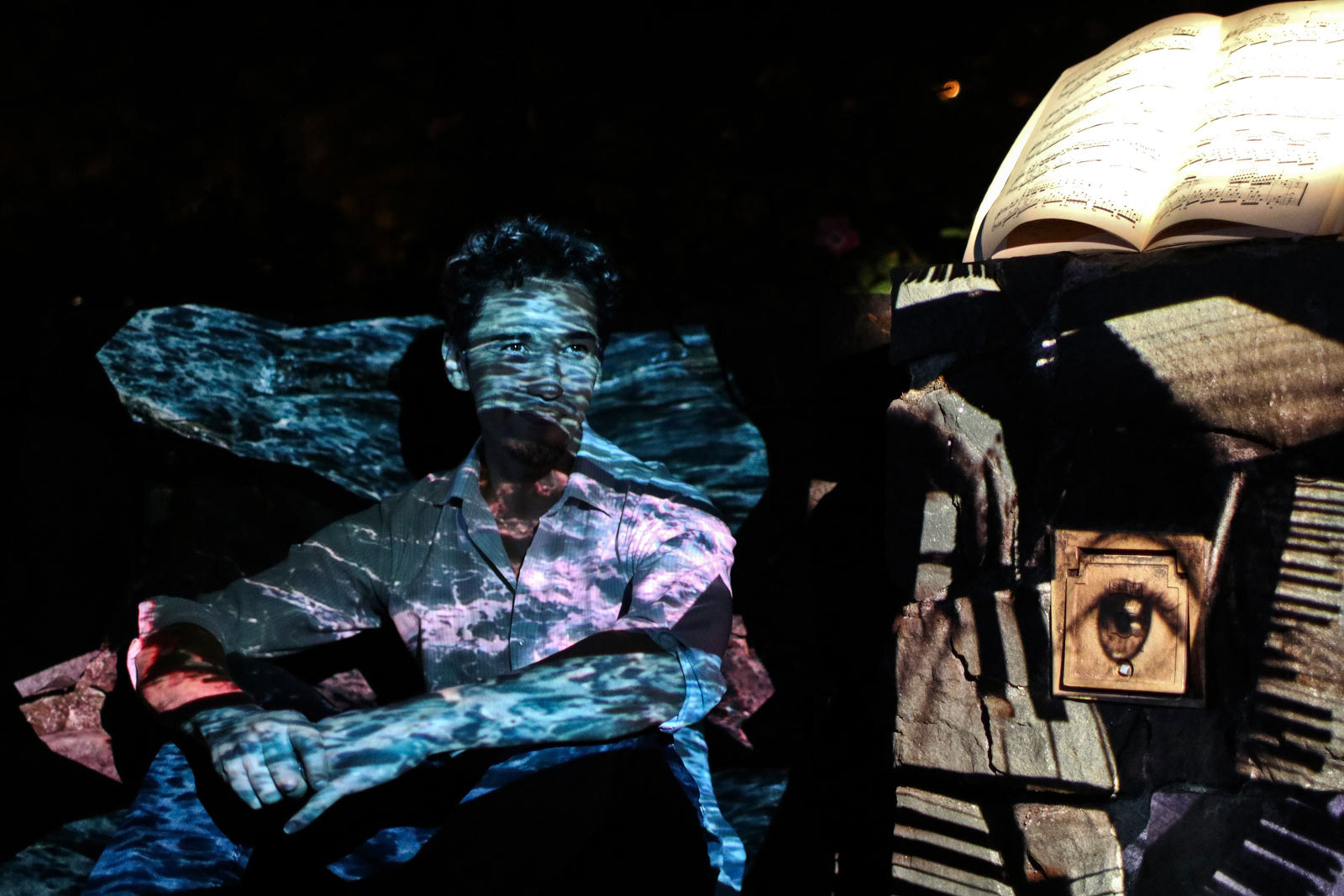 Artist John Park sits within his interactive installation at a Eugene event