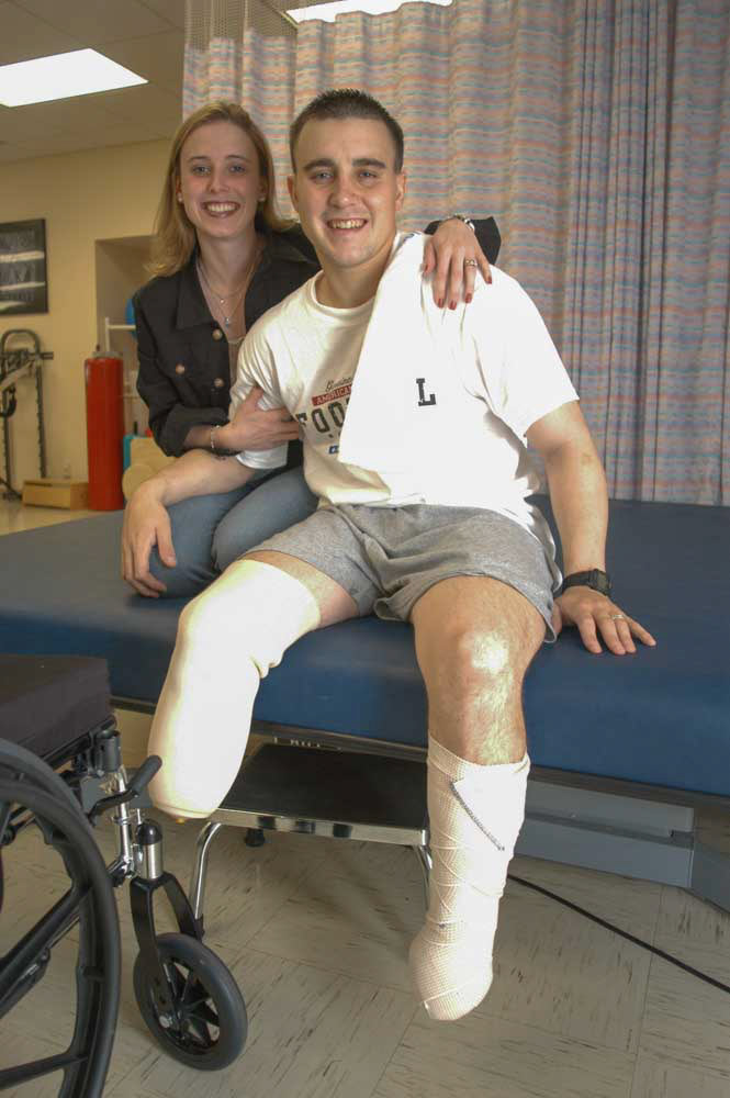 Iraq war veteran Lt. John Fernandez with his wife Kristi in the physical therapy facility at Walter Reed Army Hospital, May 8, 2003