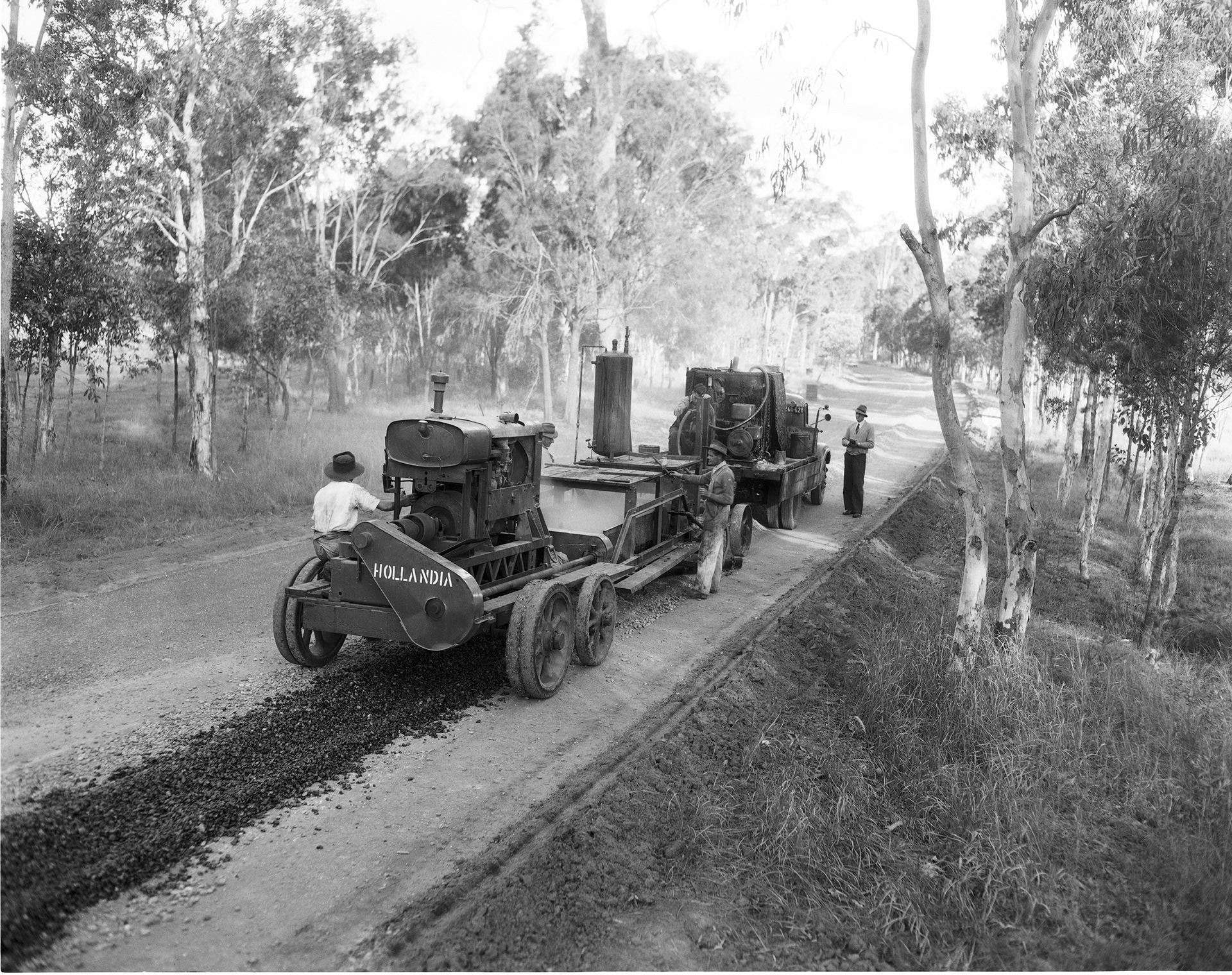 Laying ashpalt with a Hollandia hot mix machine on the Bruce Highway Redcliffe June 1951