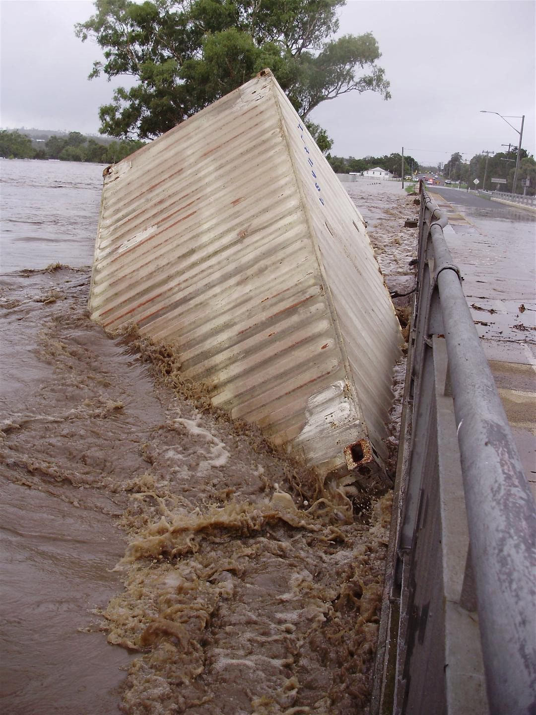 Shipping container caught in Condamine River flood waters at McCahon Bridge