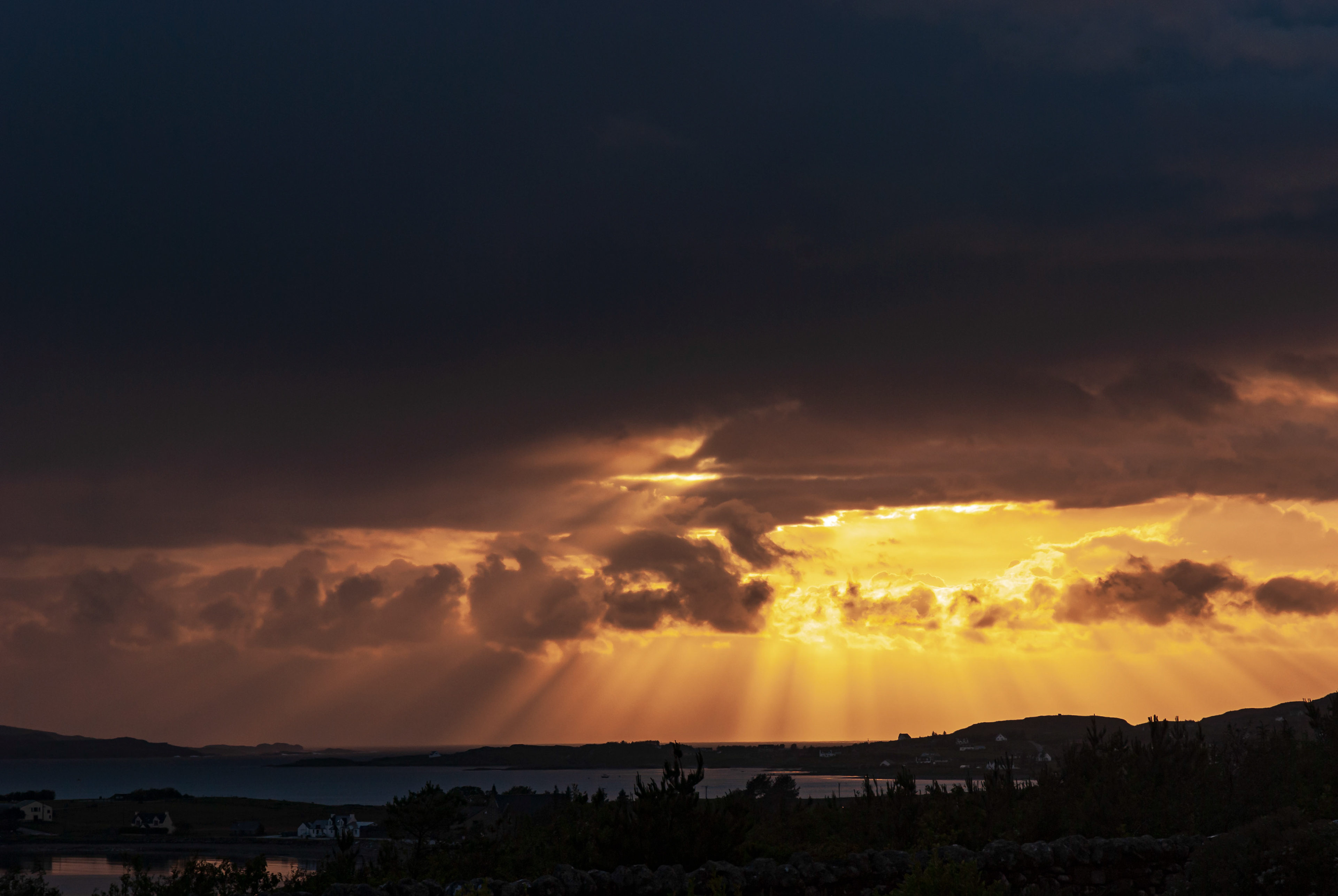 Sunset and crepuscular rays over Aultbea, Scotland