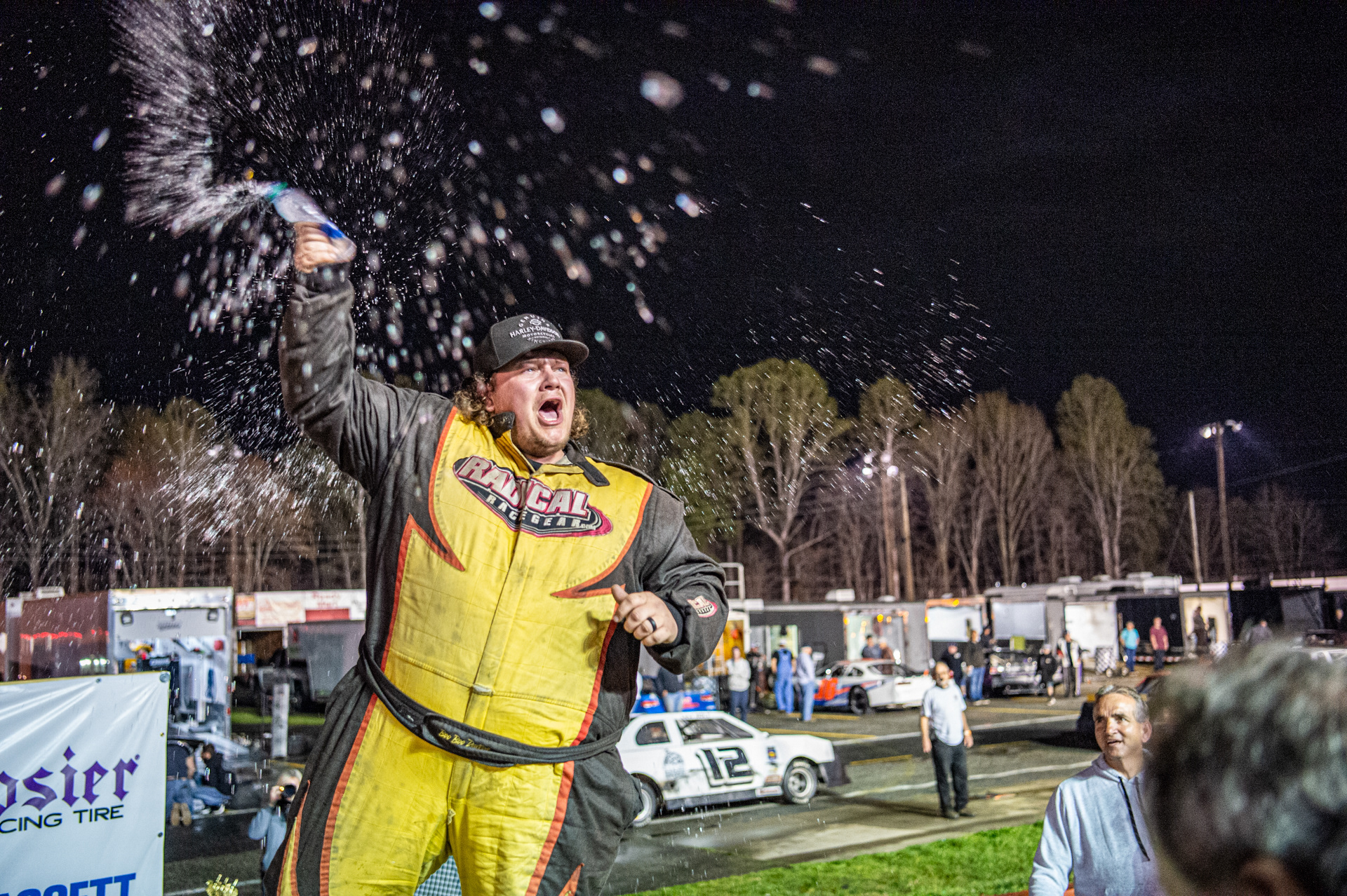 Ross "Boo Boo" Dalton throws water in celebration of his win in the Late Model Sportsman class at Caraway Speedway's Twin Night at the Races on March 27, 2021.