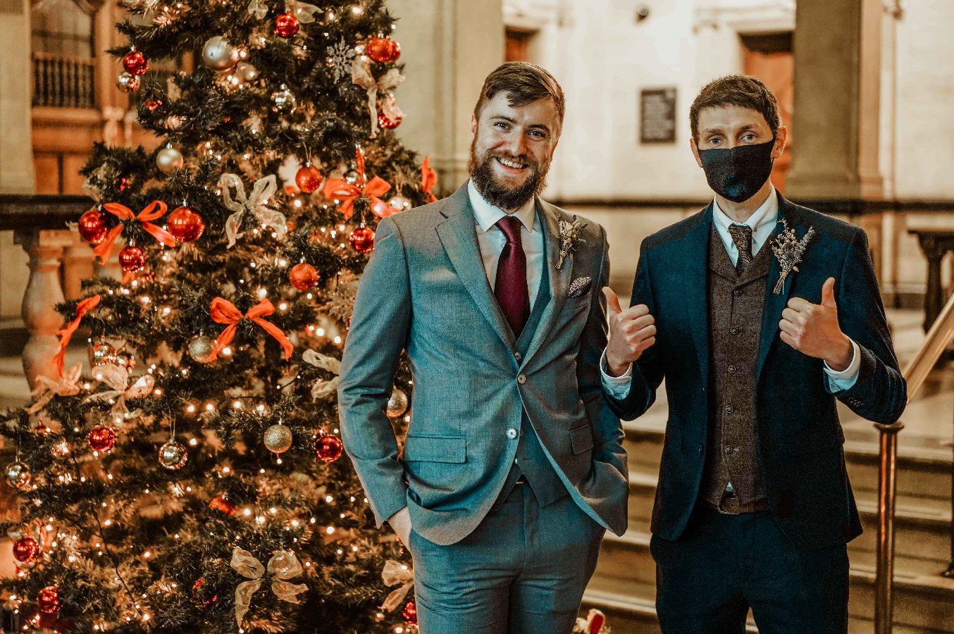 december wedding in oxford town hall with best man and groom stood by christmas tree with wedding photographer david lefebvre