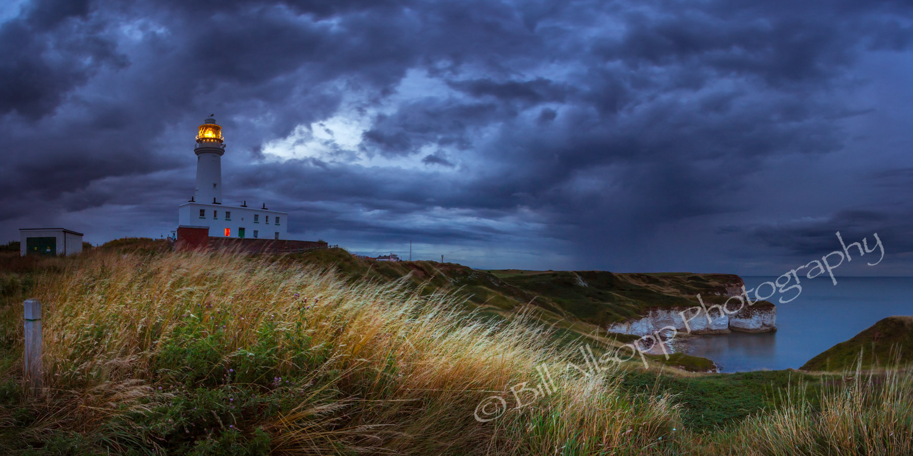 A rainstorm moves in towards Flamborough Head at twilight.