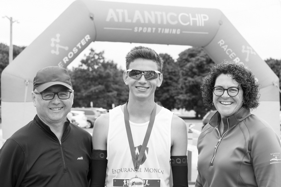 François Poirier, accompanied by his parents, following a race in Shediac, NB