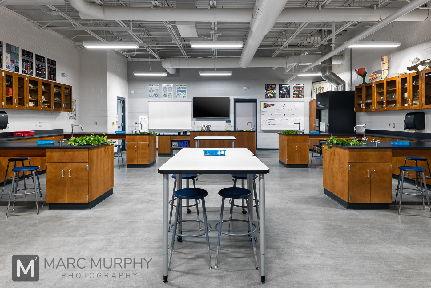 West Ridge High School Biology Lab with desks, cabinets, stools, sinks, open ceiling and block walls