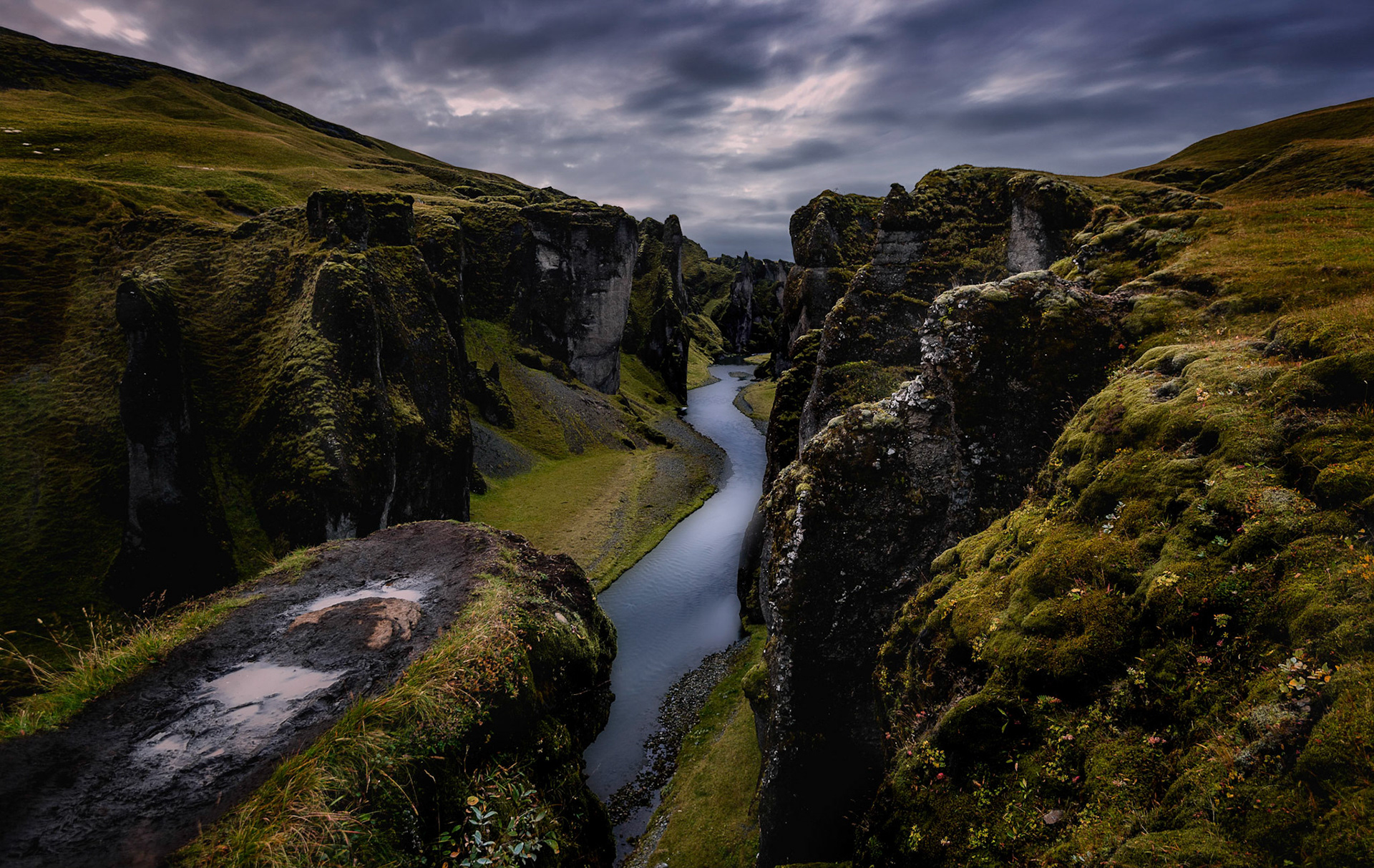 Fjaðrárgljúfur Canyon is a must see for this magical country! This canyon is one of those places in Iceland that you don't find in any of the brochures, and don't see many photos of, but that's just one of the reasons it's all that much more magical when you get there. There is a little grassy walking trail along the side of the canyon, with dramatic views to the floor that would make even the most experienced climbers dizzy. The canyon is 100m tall and 2km long, and you can also hike along the floor of the canyon, although be prepared to wade through glacial rivers for that adventure! The mossy floor with trails that seemingly lead into an abyss, and the blue waters with the occasional waterfall make you feel like you are surrounded by fairies and trolls (and ask any Icelander, you just may be!).