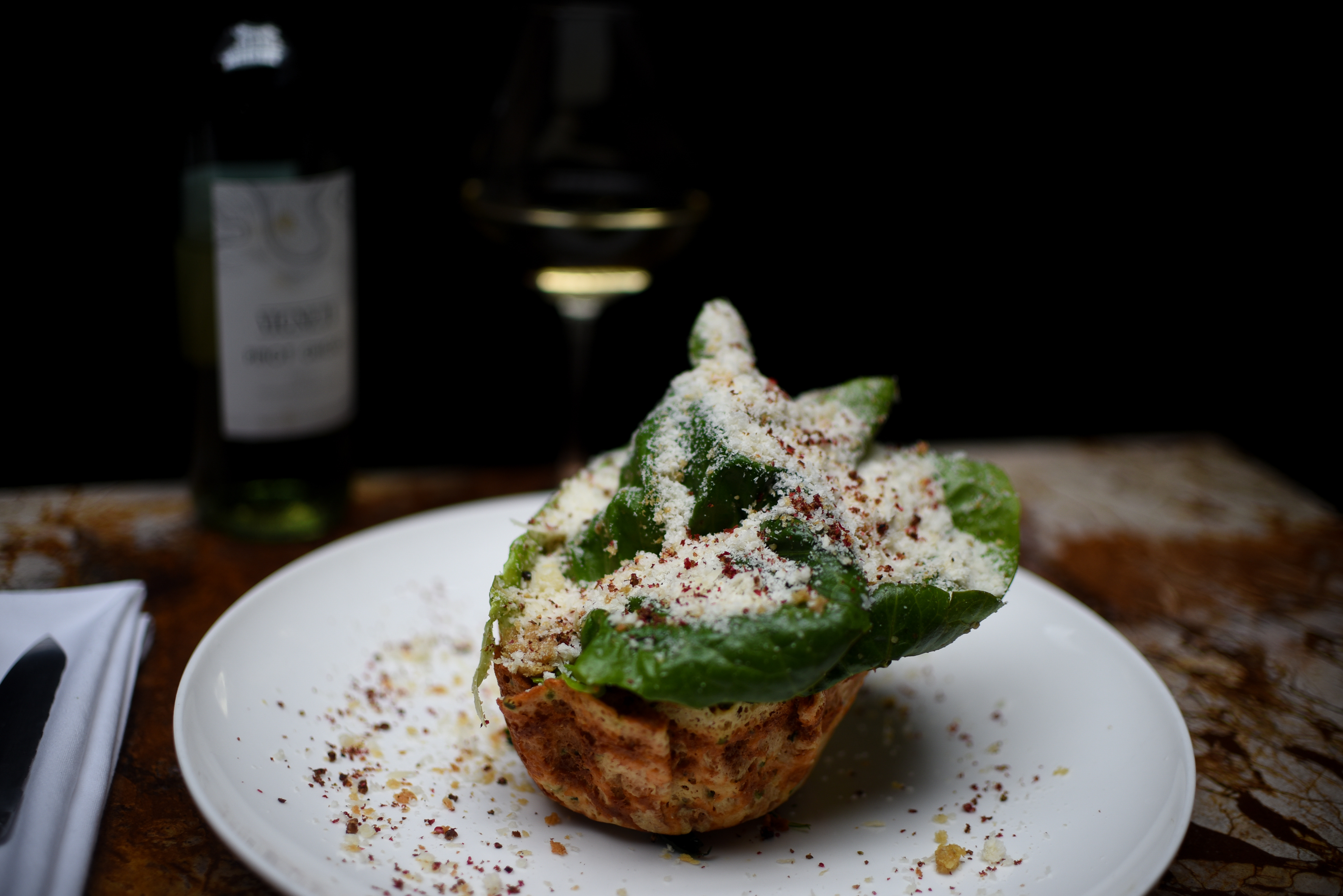 “LIL’ GEM” CAESAR SALAD Grana Padano Snow, Crispy Chicken Skins, Brown Butter Crumble