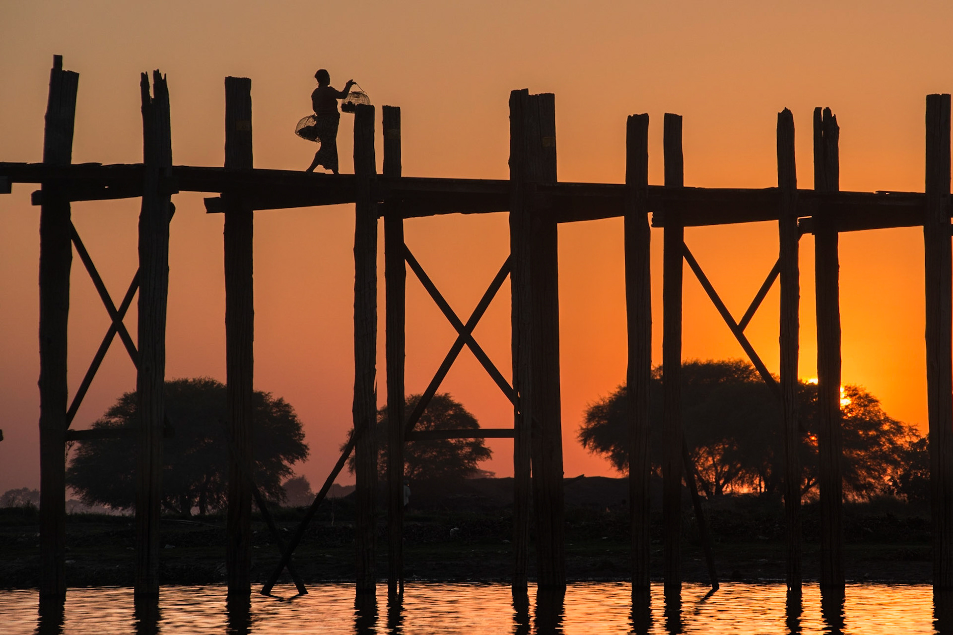 U Bein Bridge  is a crossing that spans the Taungthaman Lake near Amarapura in Myanmar. The 1.2-kilometre (0.75 mi) bridge was built around 1850 and is believed to be the oldest and longest teakwood bridge in the world. Construction began when the capital of Ava Kingdom moved to Amarapura, and the bridge is named after the mayor who had it built. http://en.wikipedia.org/wiki/U_Bein_Bridge