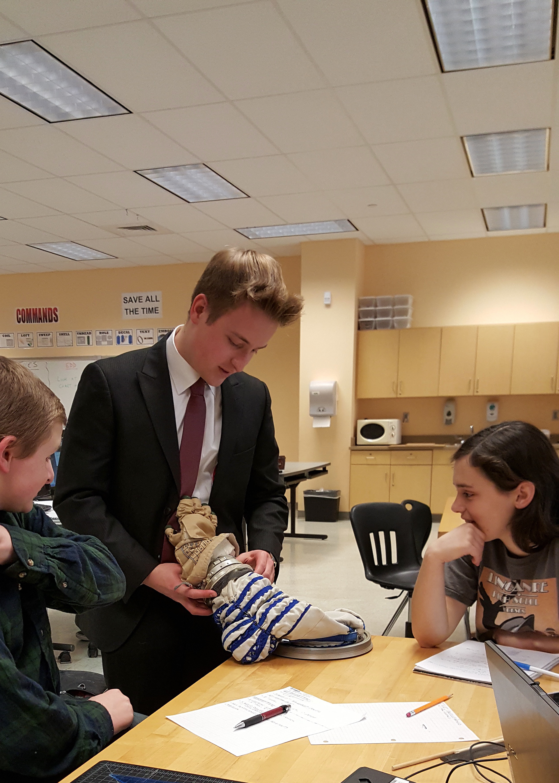 The team conducting outreach activities at Linganore High School in Frederick, Maryland, including a presentation on the TERRAPIN device and guiding students through spaceflight-related activities.