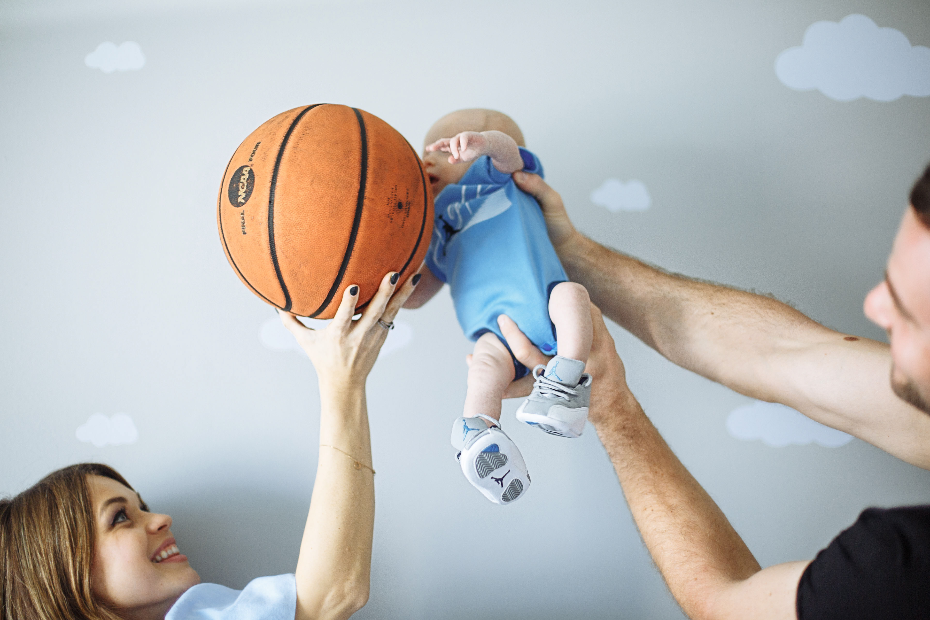 newborn baby playing basketball