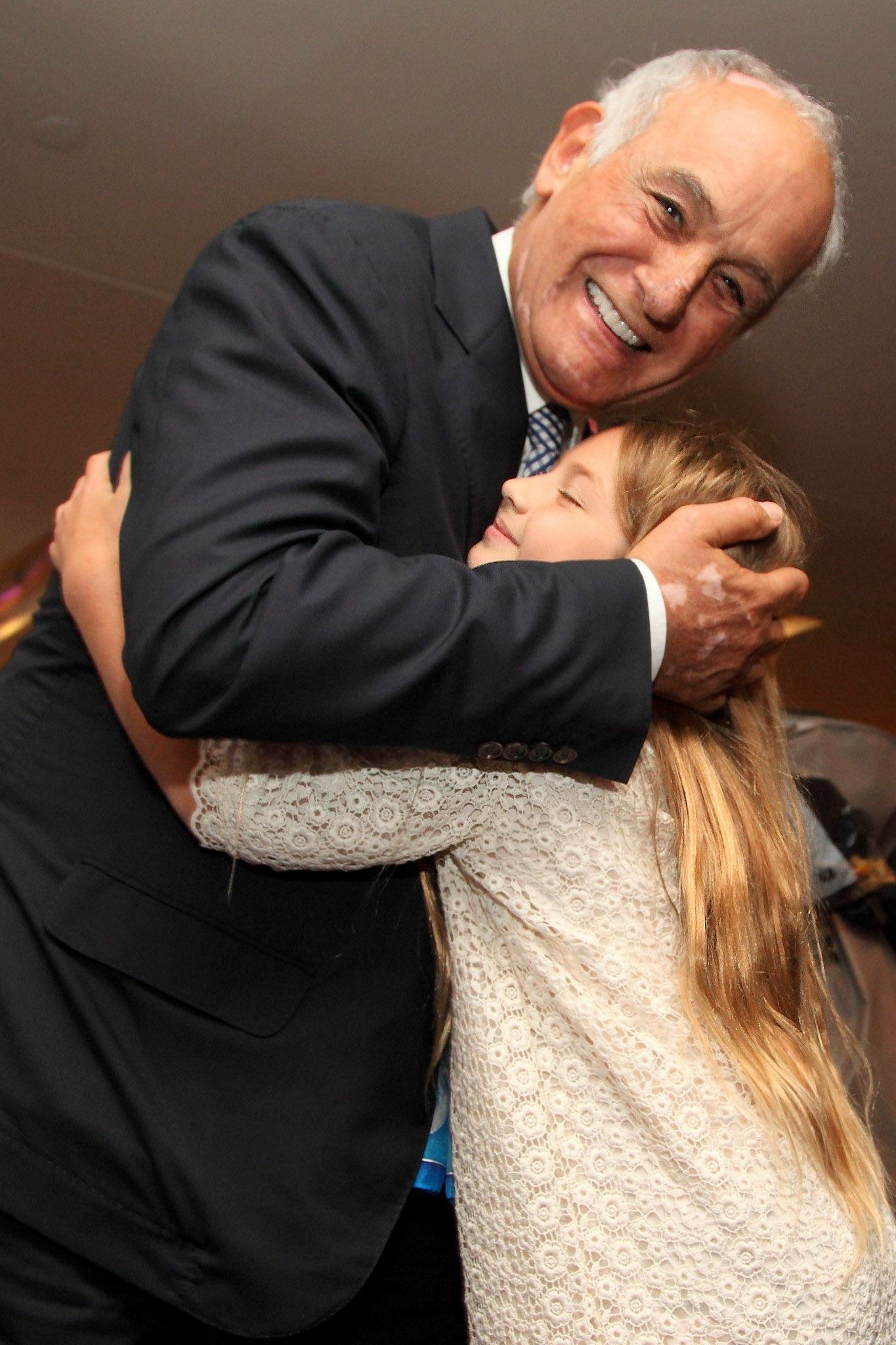 A young well-wisher hugs Aldo Bensadoun after the 2012 Faculty of Management Convocation ceremony where he received a honorary doctorate.  June 2012.
