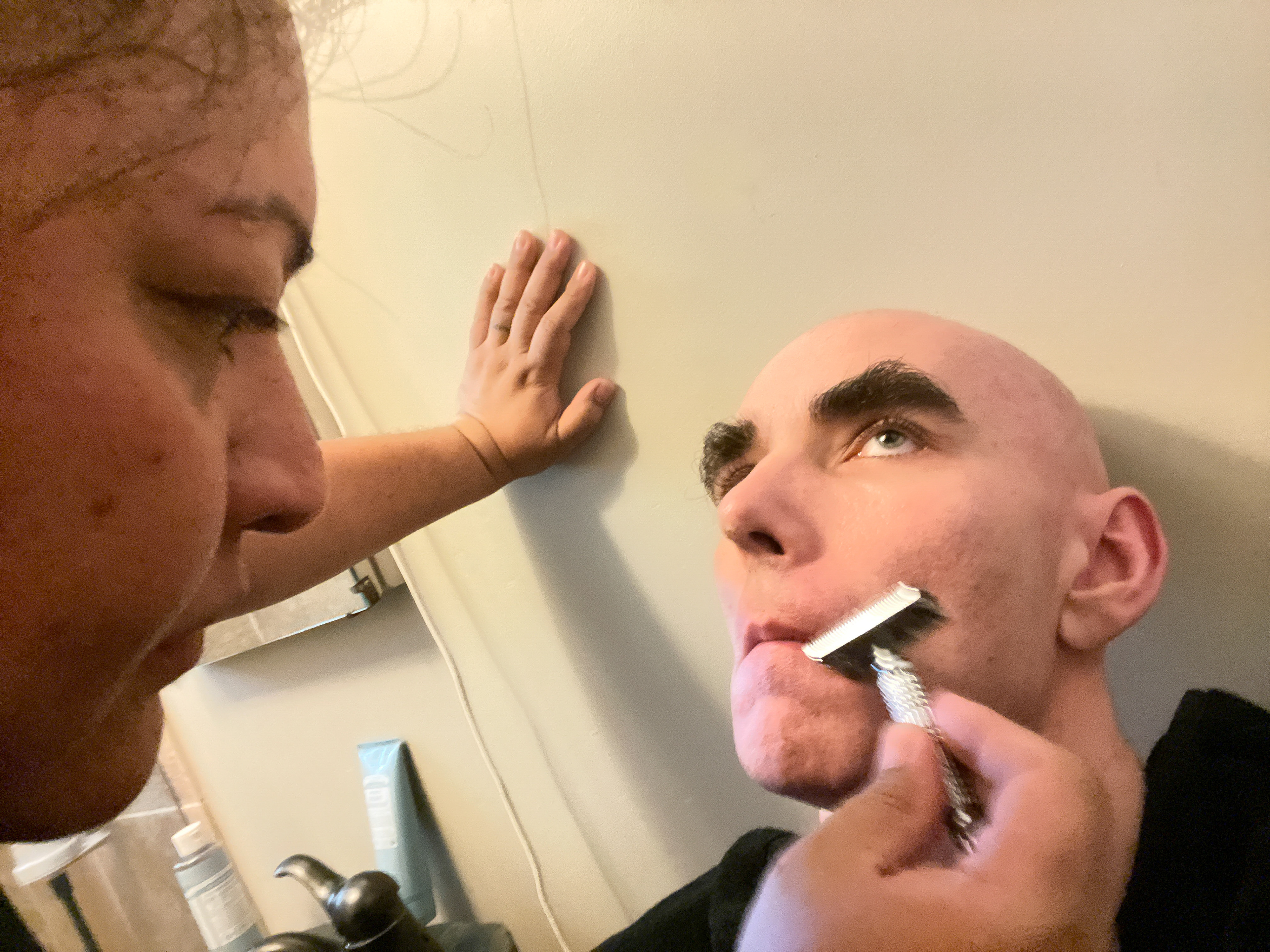 My caregiver shaving my head and face.