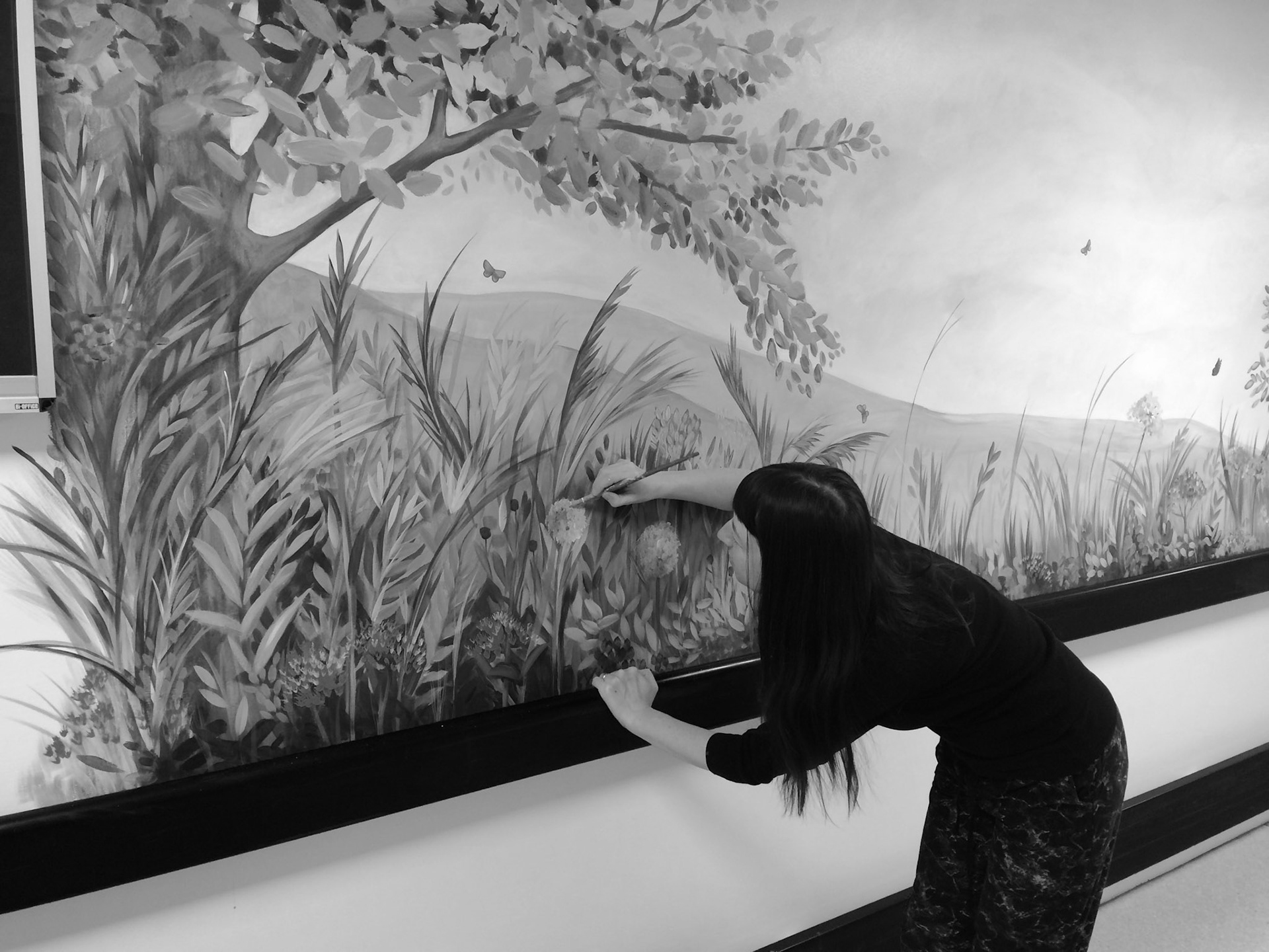 Lynne painting a mural