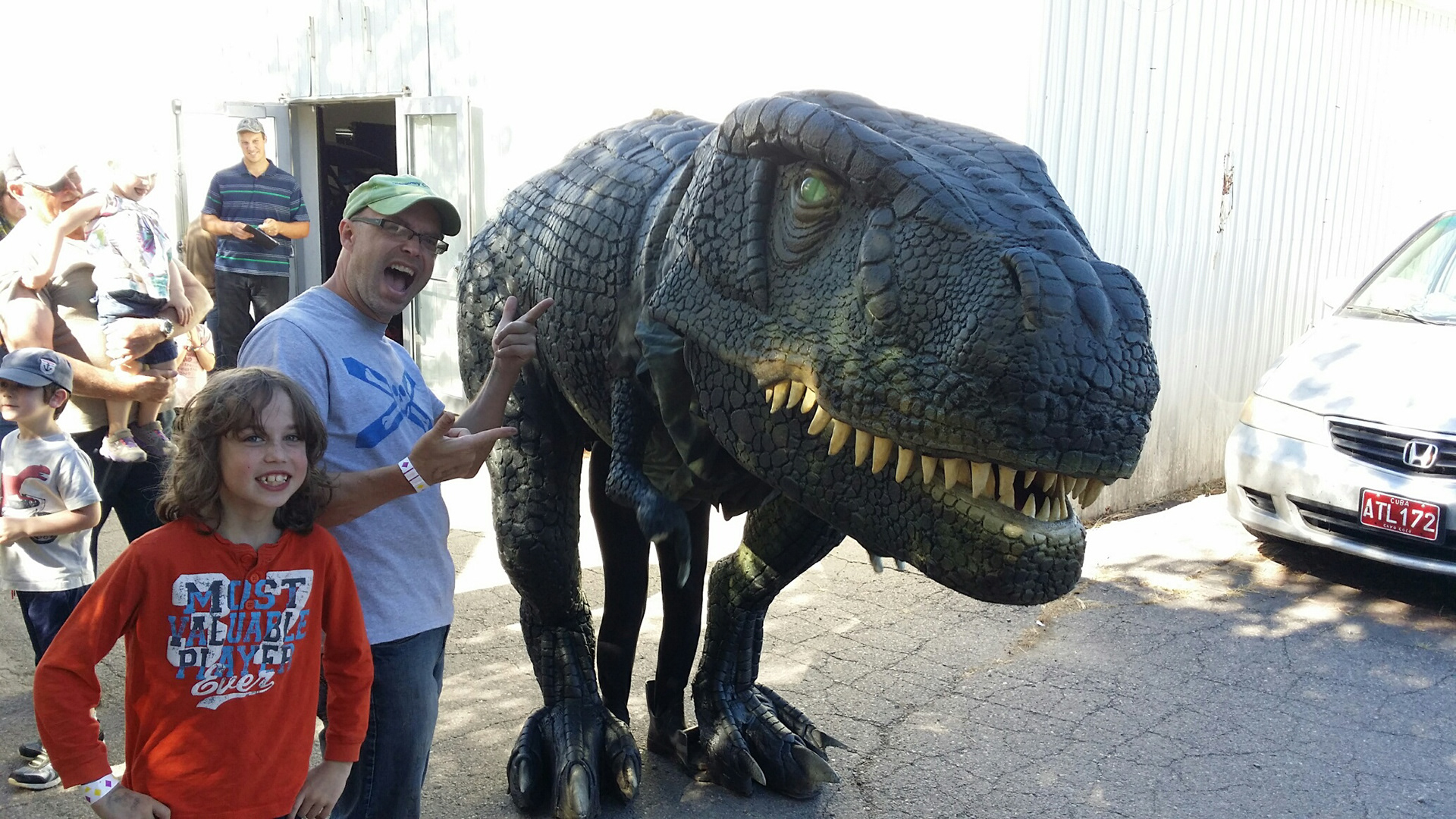 Allan Carver and son in front of the dinosaur costume they built.