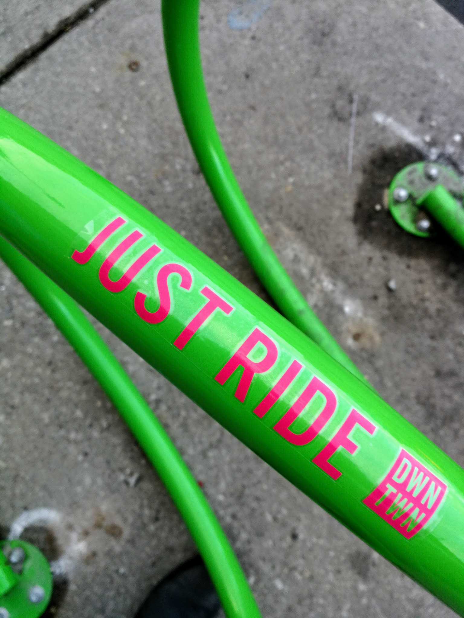 vinyl lettering installed on several outdoor bike racks