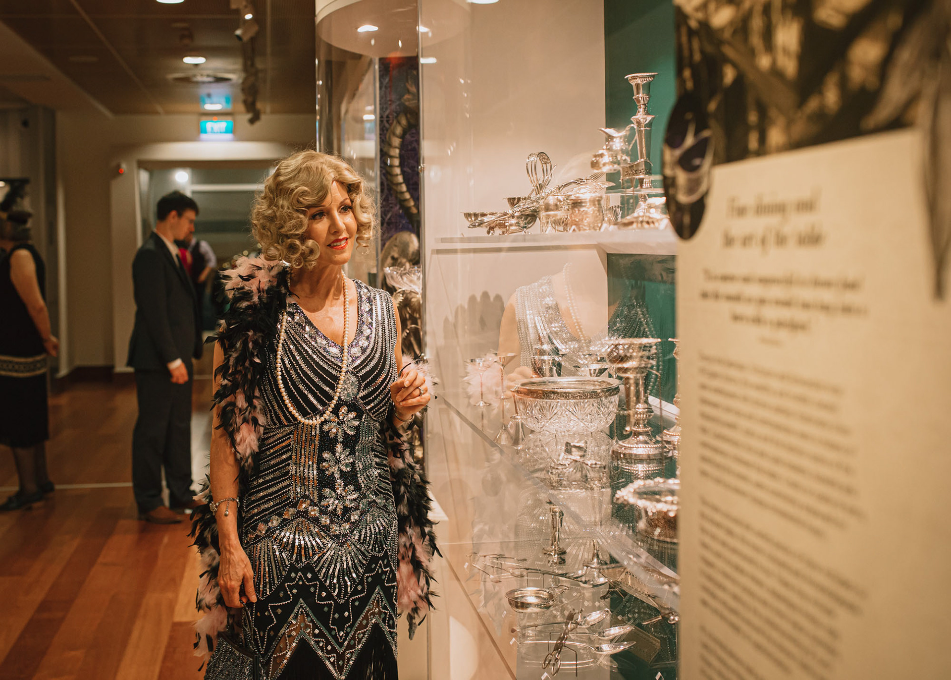 Guest dressed in evening wear viewing the art deco exhibition at the MTG Hawke's Bay