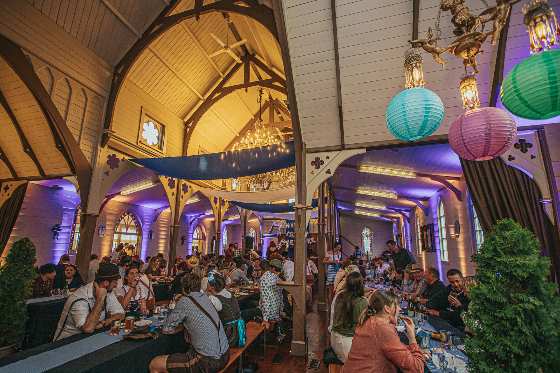 Wide view of the Old Church interior with festival guests